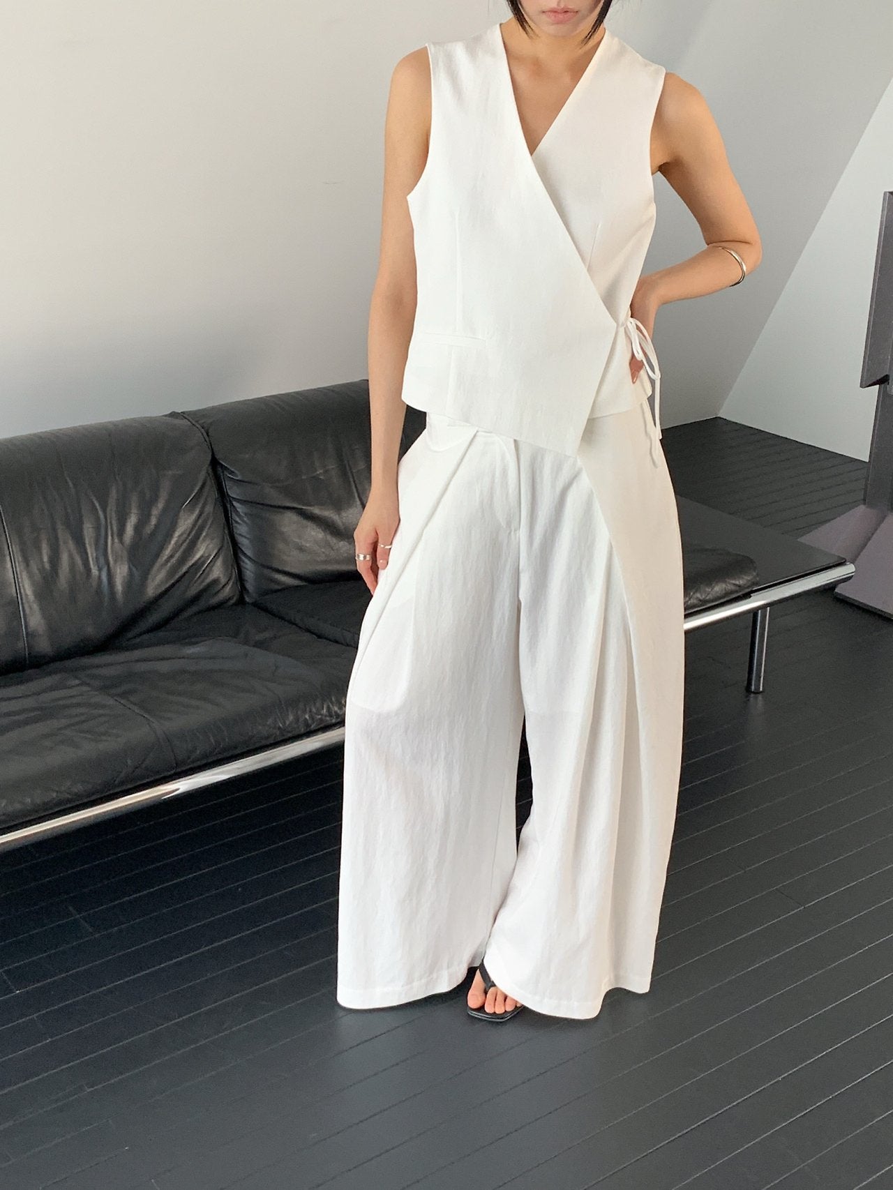 Vivel high waist deep pleat wide leg pants in White, styled on model front view close-up pleat and waist detail with white wrap top