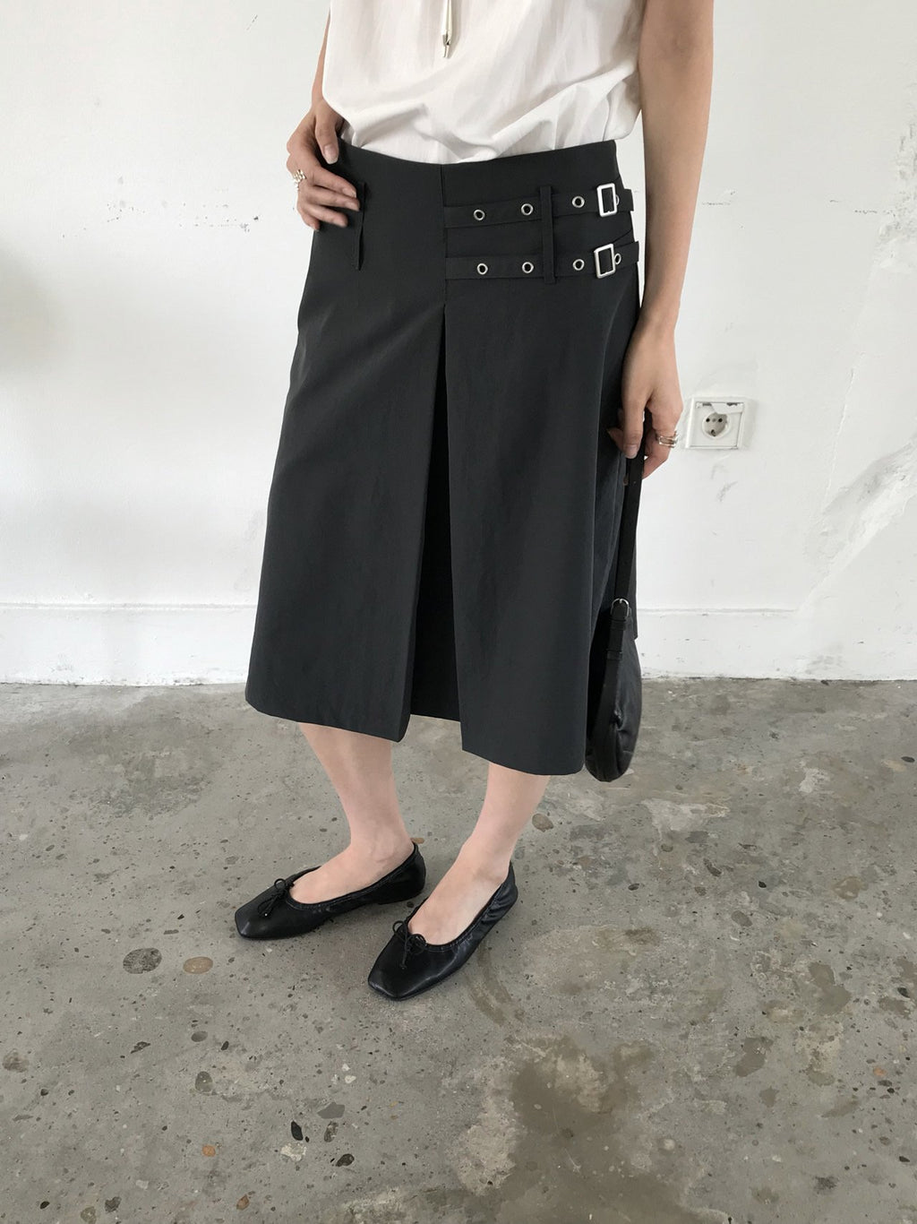 Newol Double Buckle Eyelet Pleated Midi Skirt — Asymmetric Hem