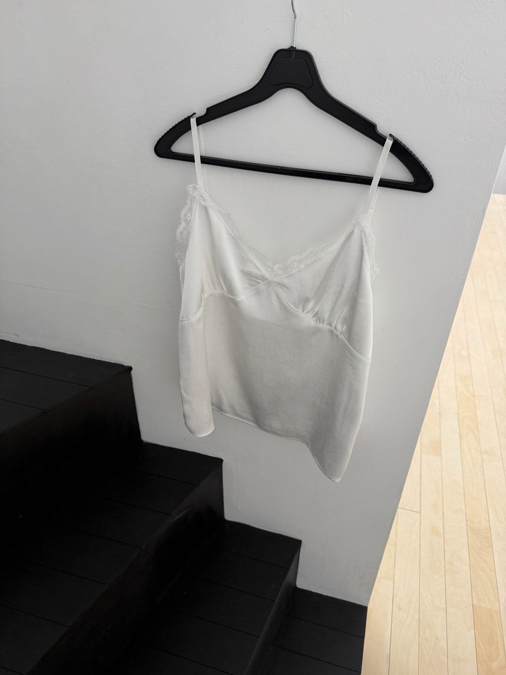 Nweol lace trim satin tank top in Ivory, product flat lay on hanger against grey wall