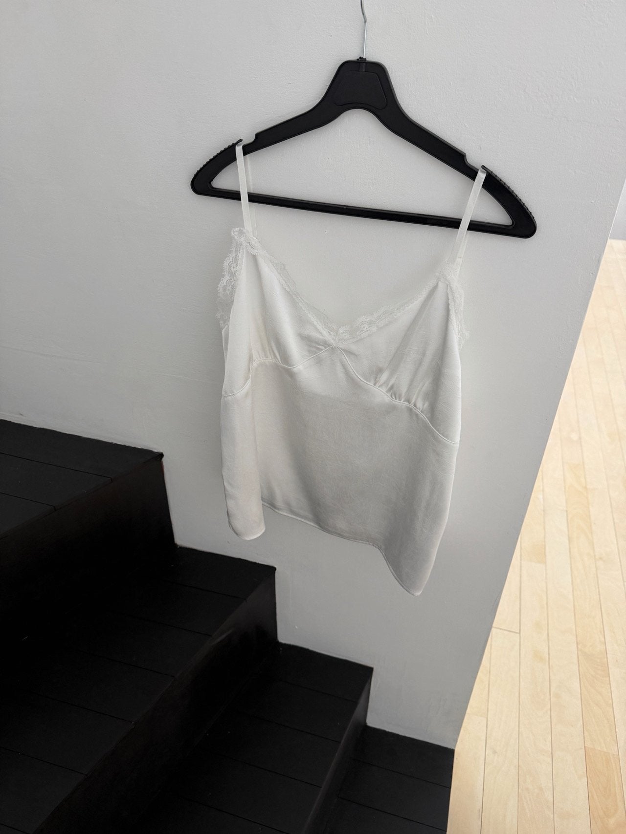 Nweol lace trim satin tank top in Ivory, product flat lay on hanger against grey wall