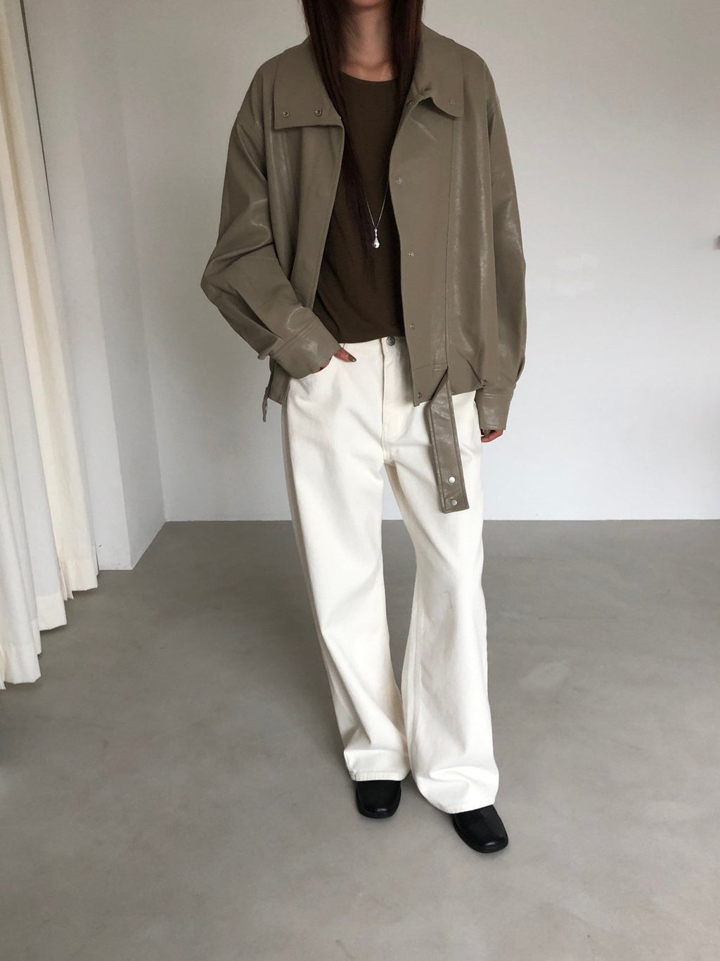 Beige jacket on hanger showing high collar and front seam details