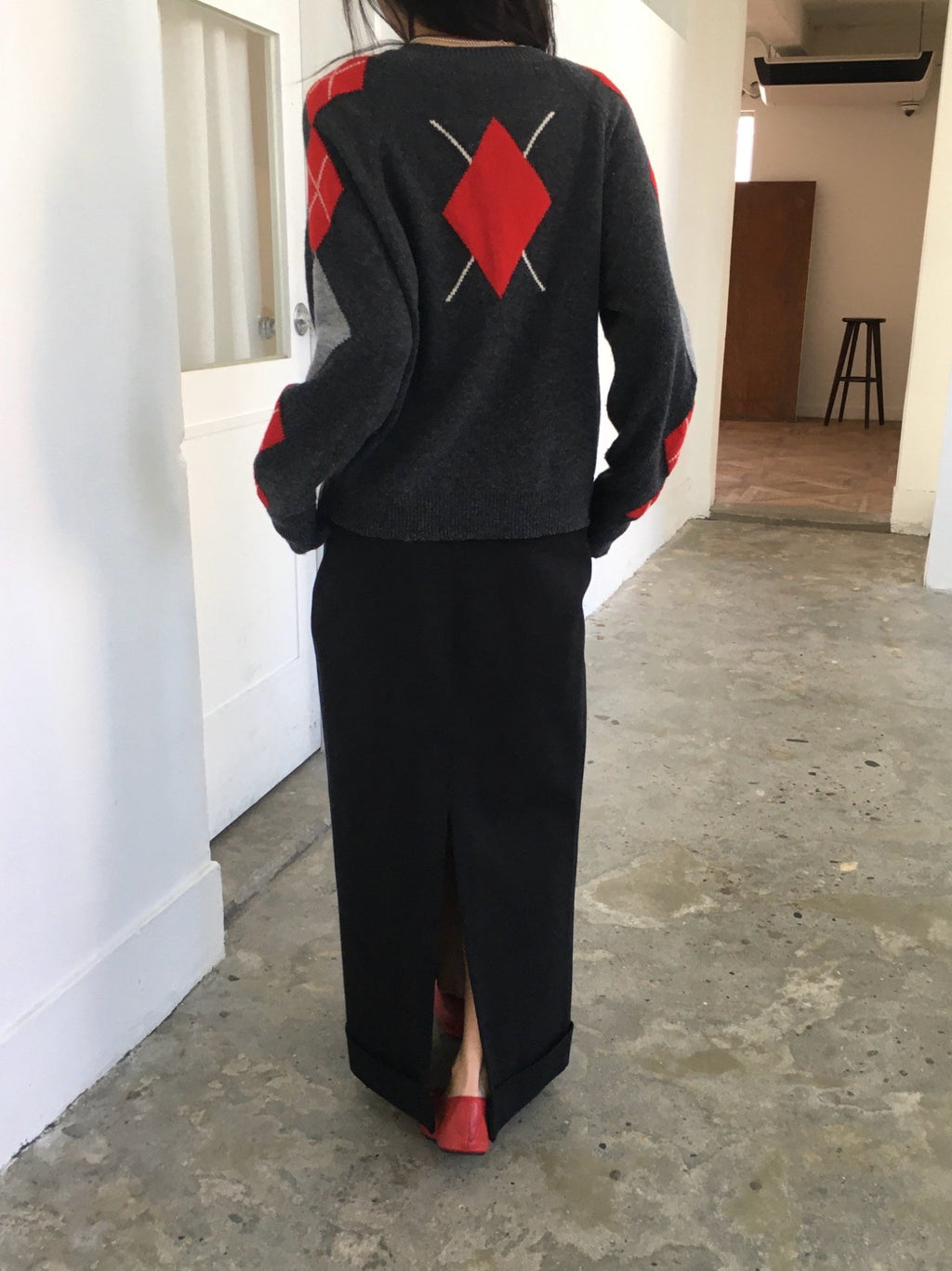 Gray wool-blend cardigan with black and ivory argyle sleeves