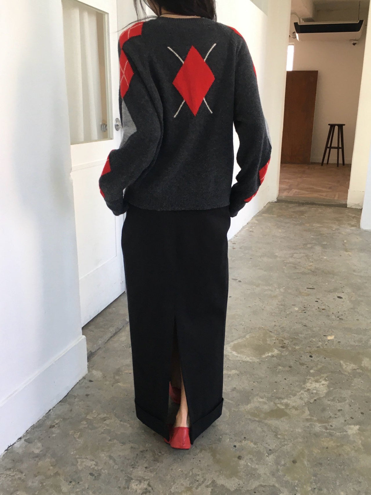 Gray wool-blend cardigan with black and ivory argyle sleeves