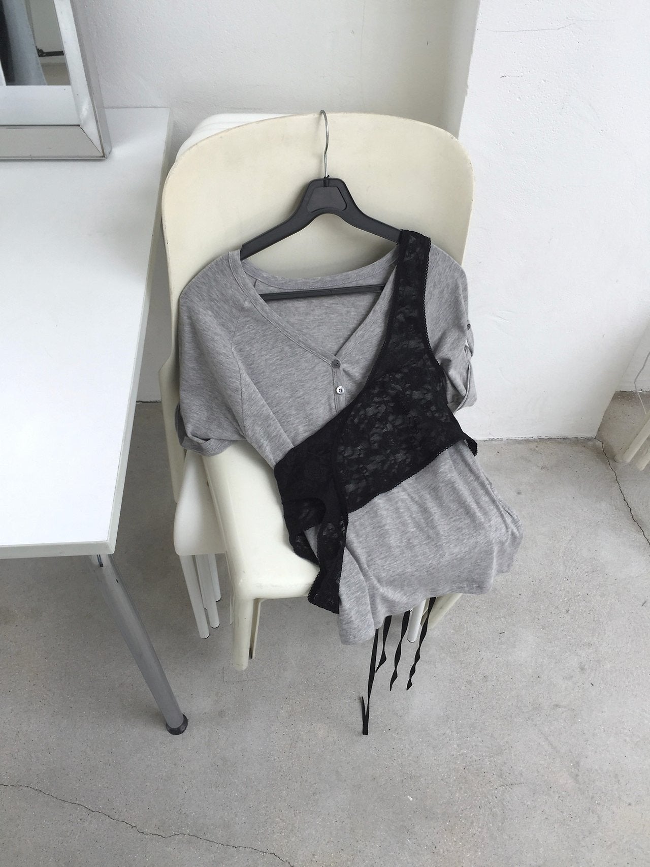 Nweol floral lace sheer bustier in Grey version, product flat lay on chair hanger with black lace version
