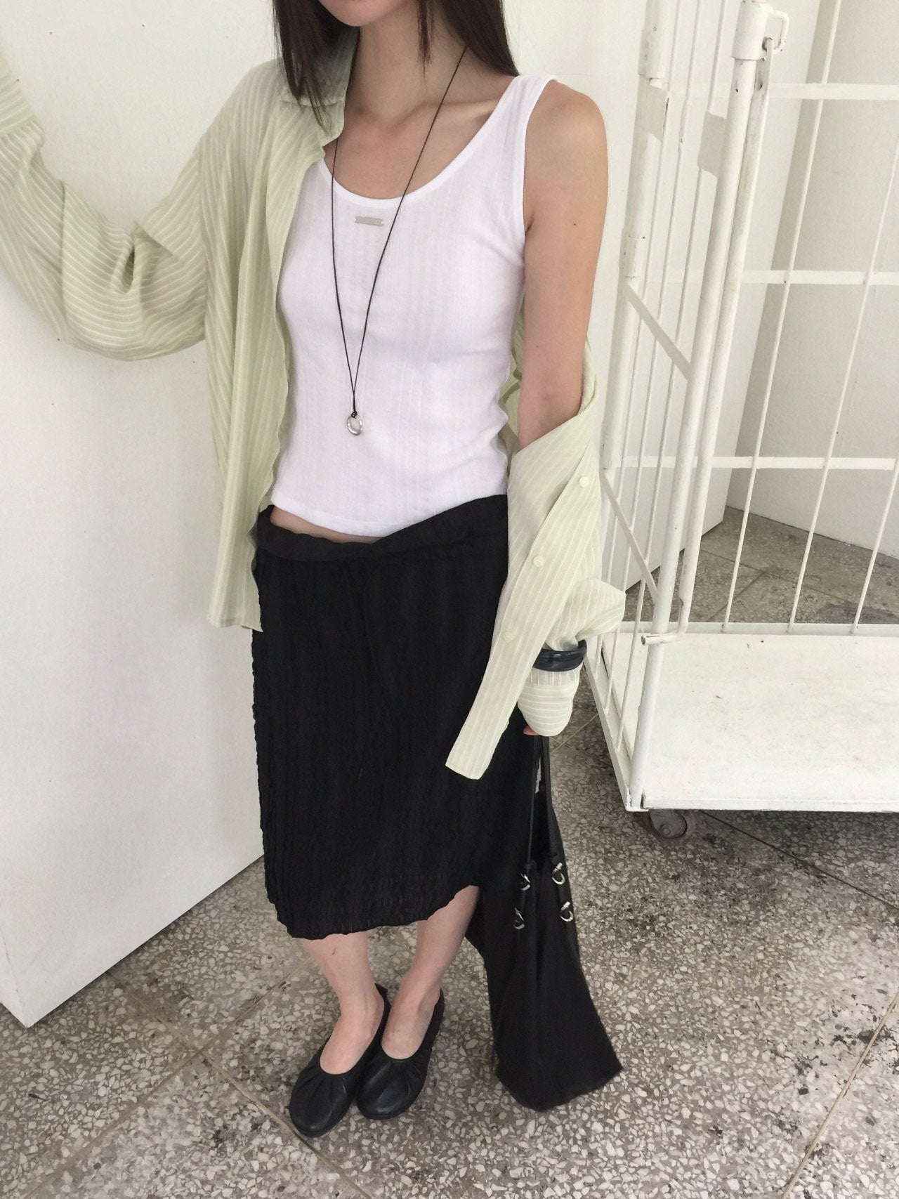 Nweol bubble texture midi skirt in Ivory, styled on model front view with olive cardigan and grey tank top