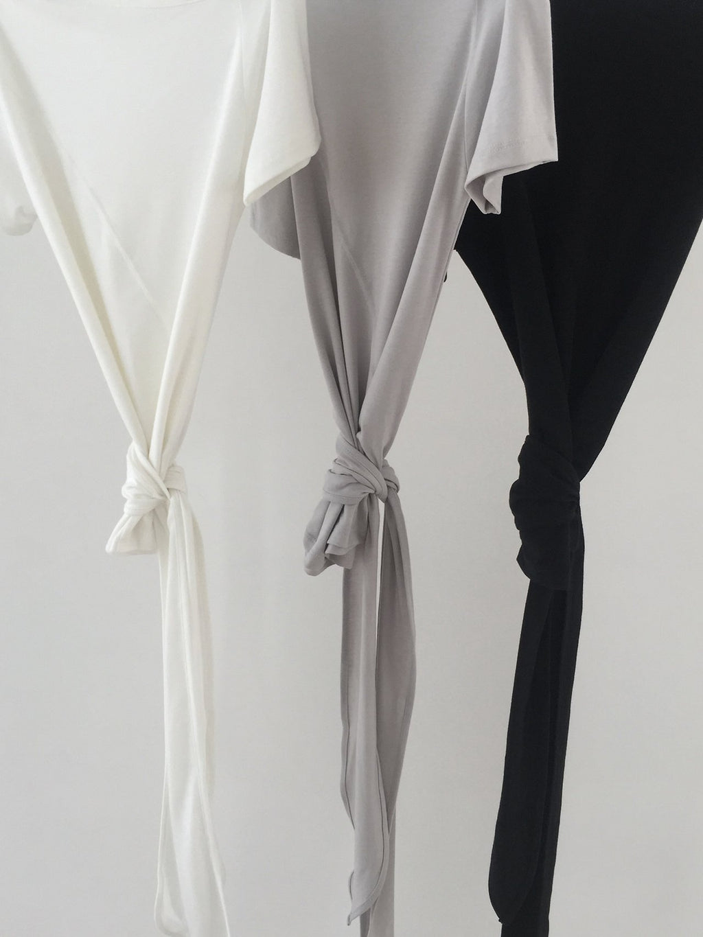 Nweol off-shoulder crop top with tie waist in Ivory, Light Grey and Black, tie string detail close-up