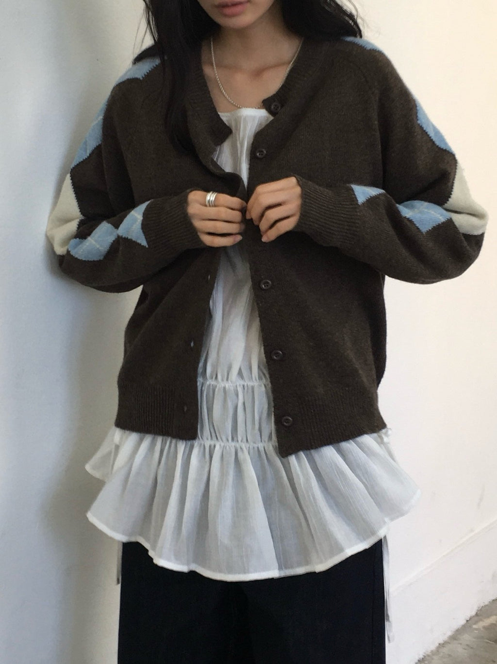 Back view of brown wool-blend cardigan with blue argyle pattern