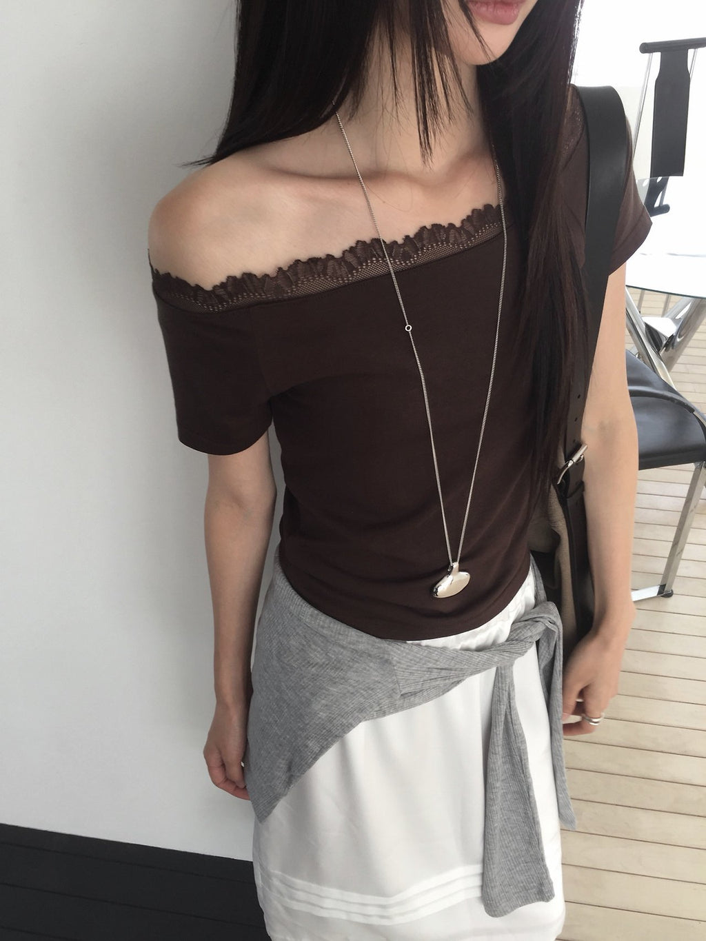 Nweol lace trim off-shoulder top in Brown, close-up lace neckline detail