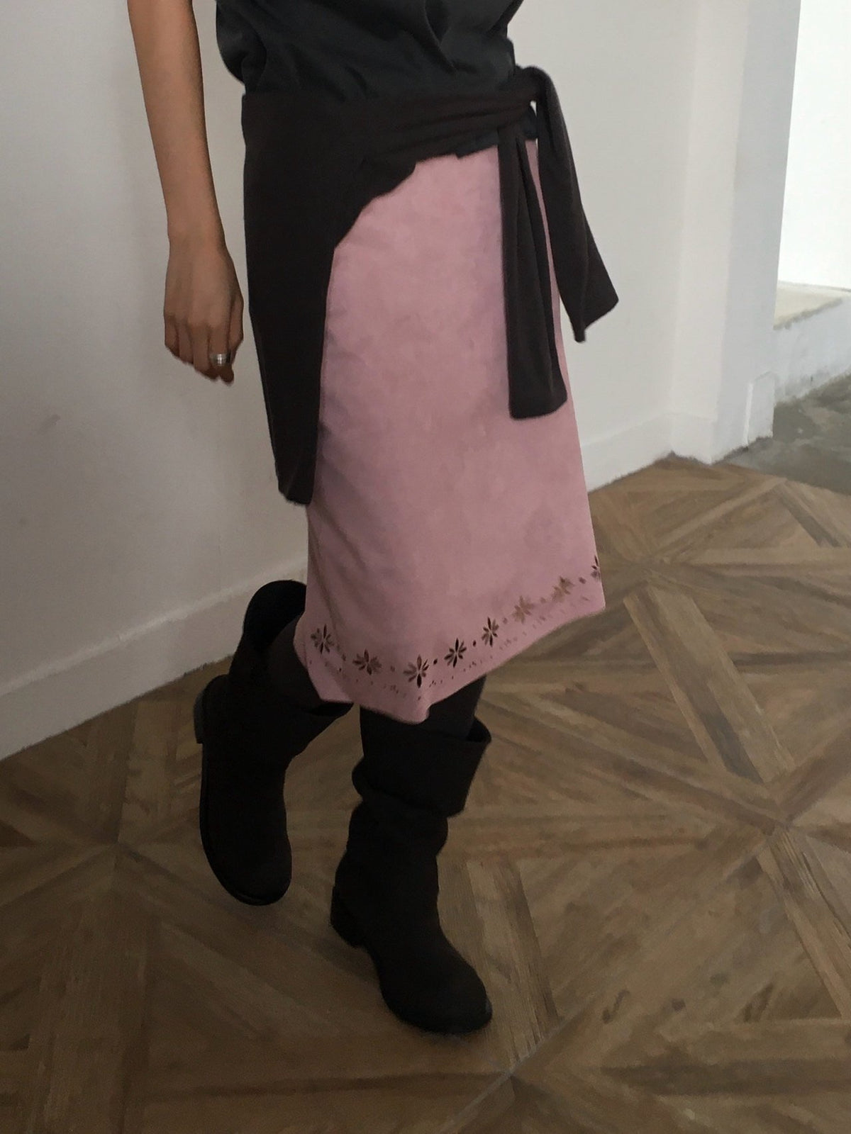 Front view of pink suede midi skirt with floral cutout detail