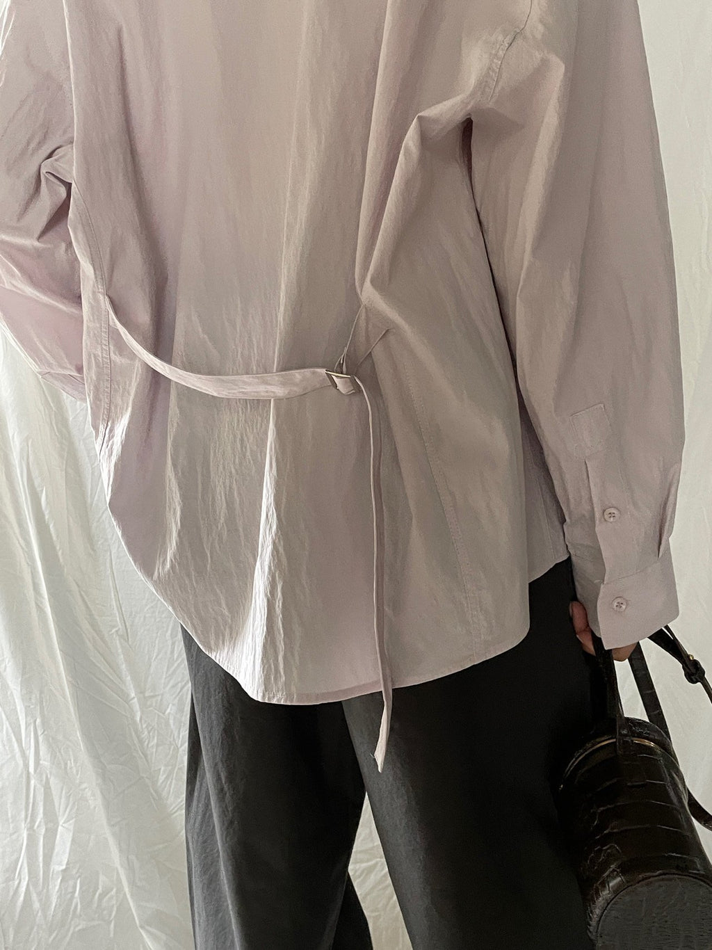 Close-up of Lucysalon Beige shirt waist belt and buckle