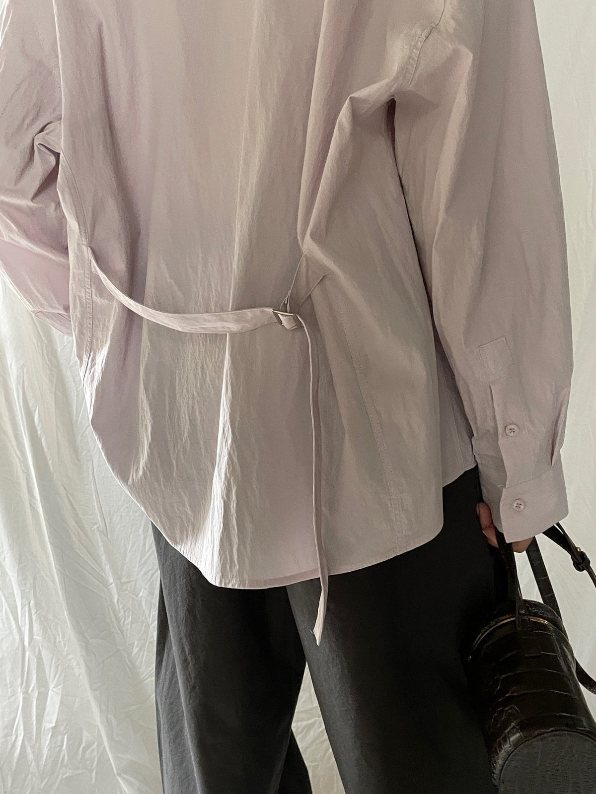 Close-up of Lucysalon Beige shirt waist belt and buckle