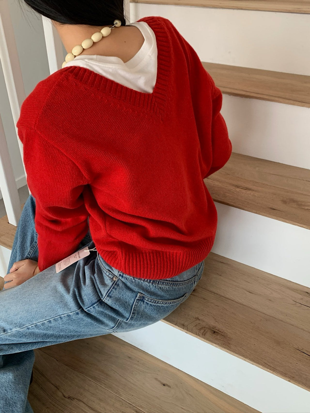 Navy two-way knit sweater layered over a shirt