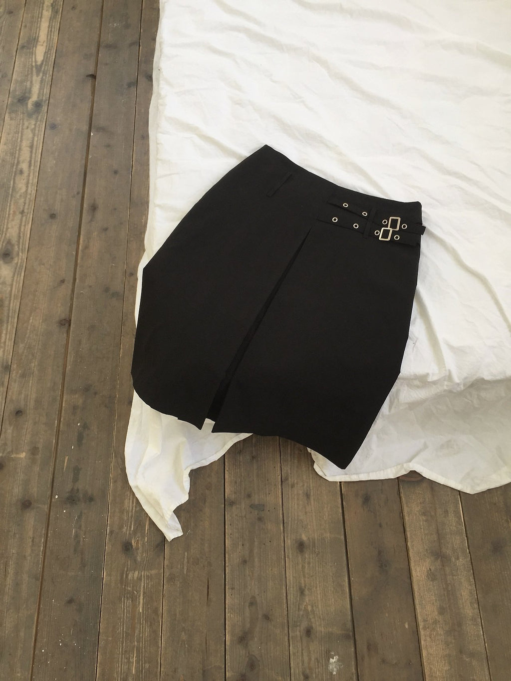 Newol Double Buckle Eyelet Pleated Midi Skirt — Asymmetric Hem