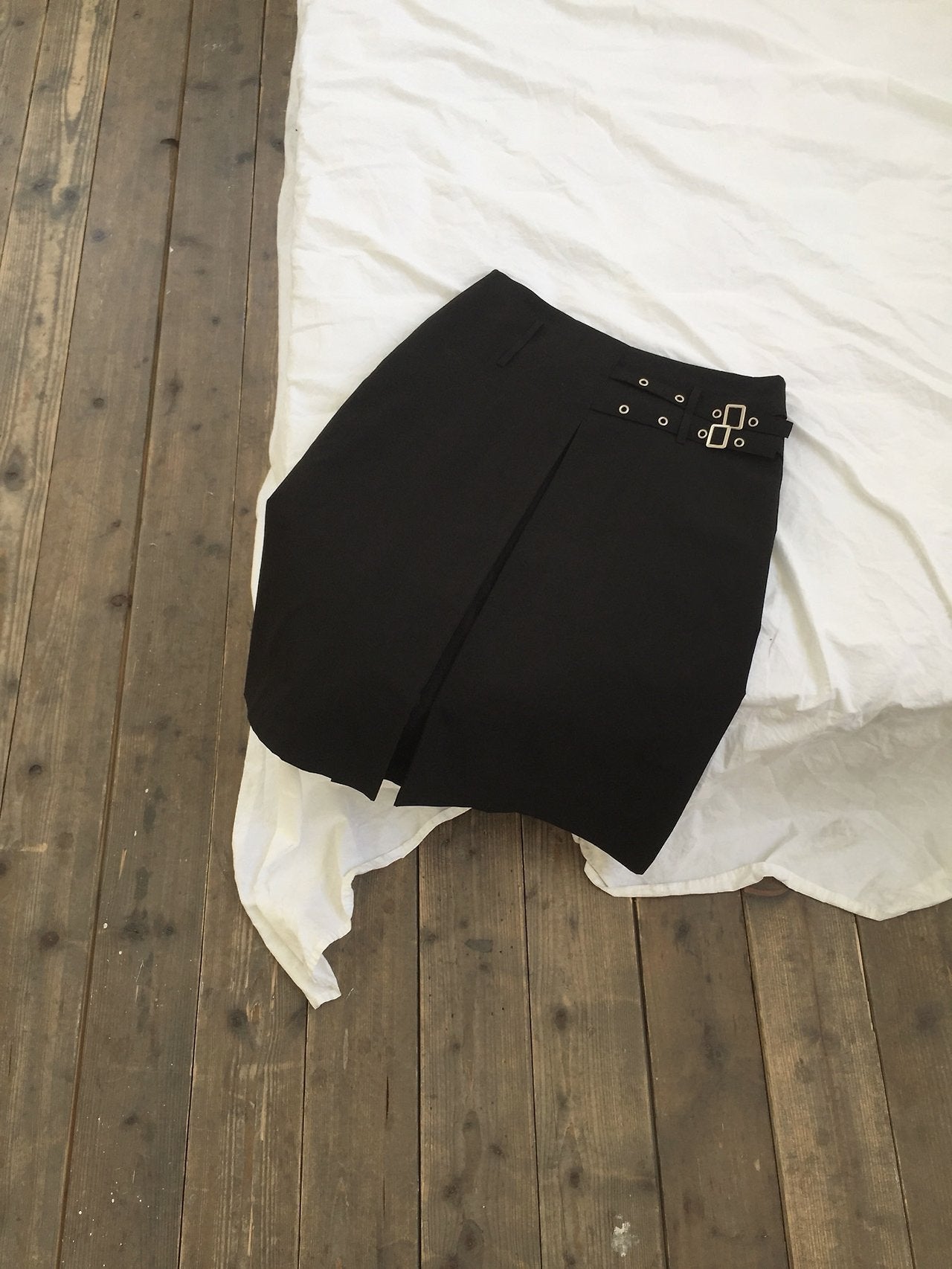 Newol Double Buckle Eyelet Pleated Midi Skirt — Asymmetric Hem