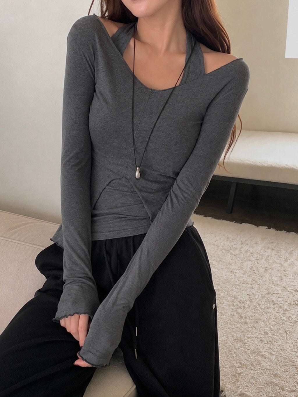 Navy halter tank top and long-sleeve V-neck top on a hanger