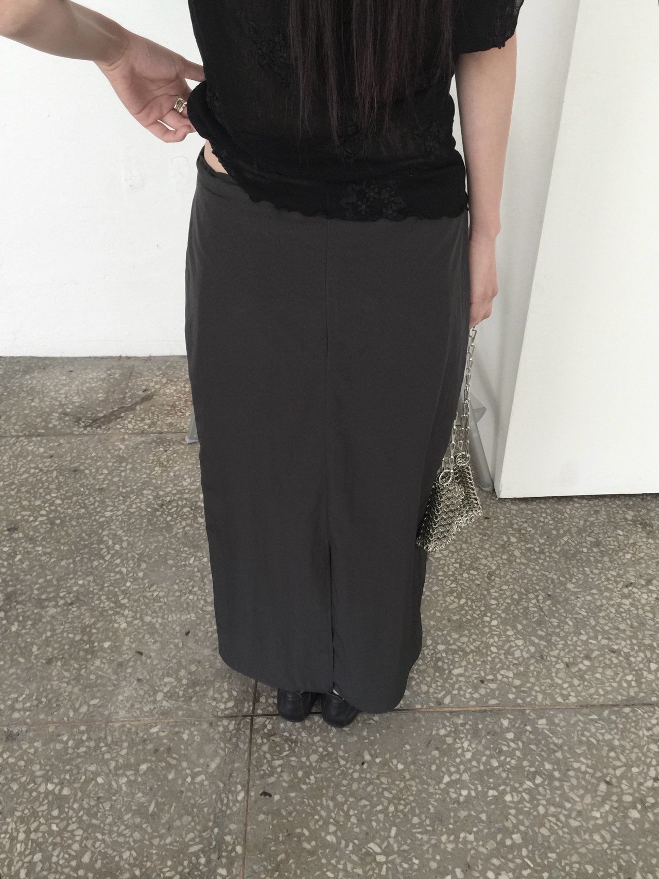 Nweol low rise zip pocket maxi skirt in Black, styled on model side view full length