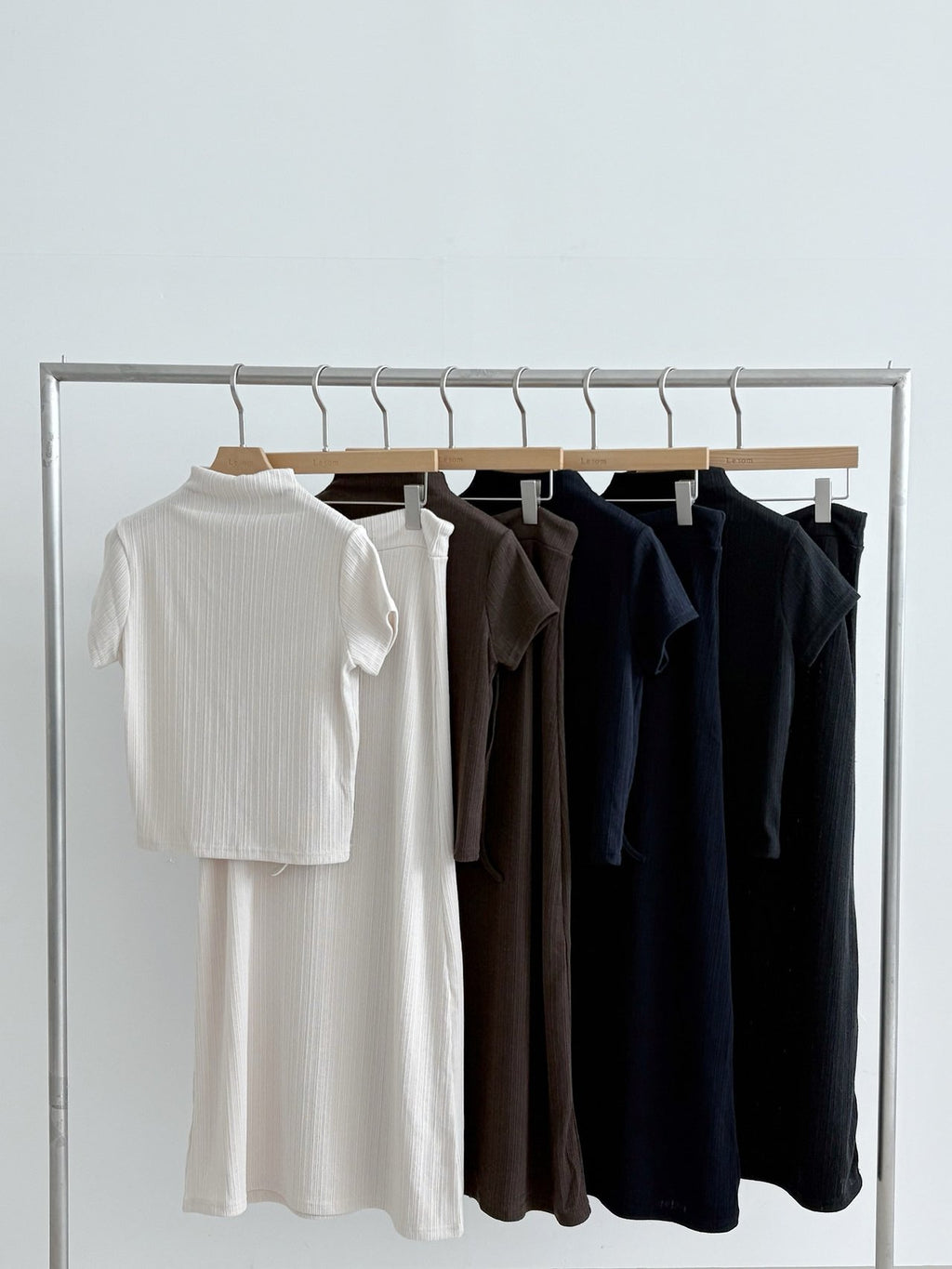 Short-sleeve pleated mock neck tops in cream, brown, navy, and black