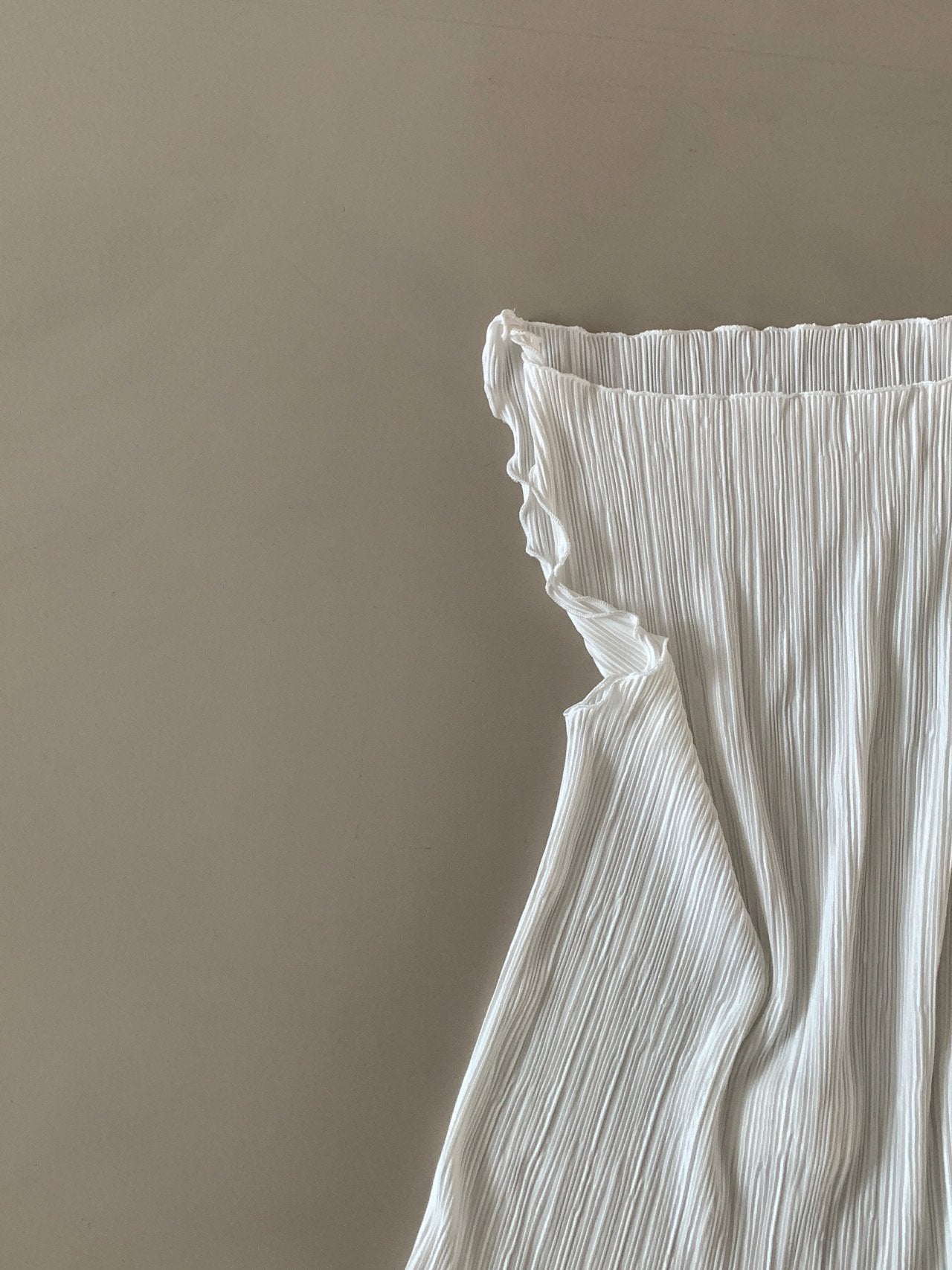 Moment pleated boat neck tank top in Light Khaki, front view close-up frill hem detail