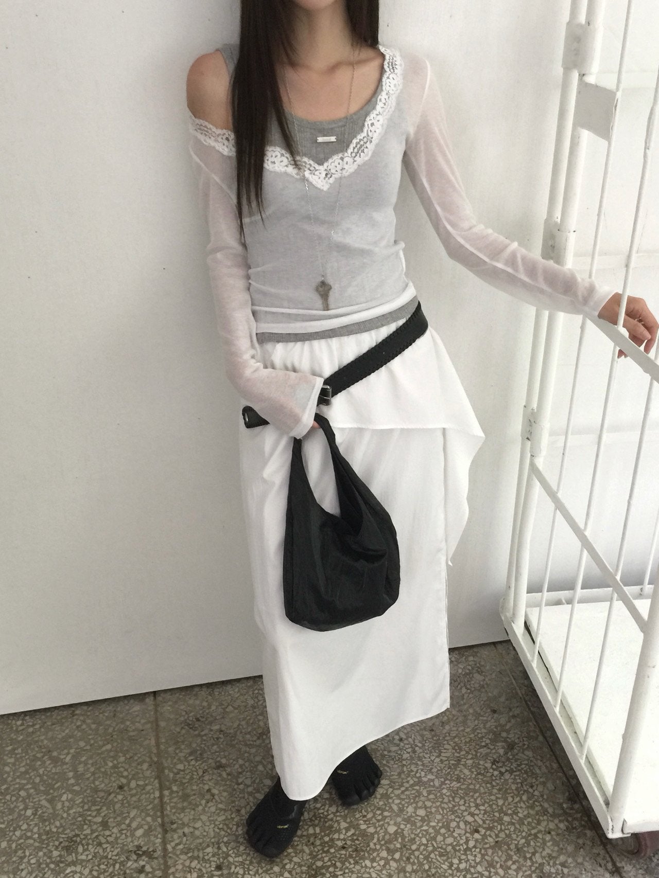 Nweol lace trim V-neck long sleeve top in Grey, styled on model front view with black shorts