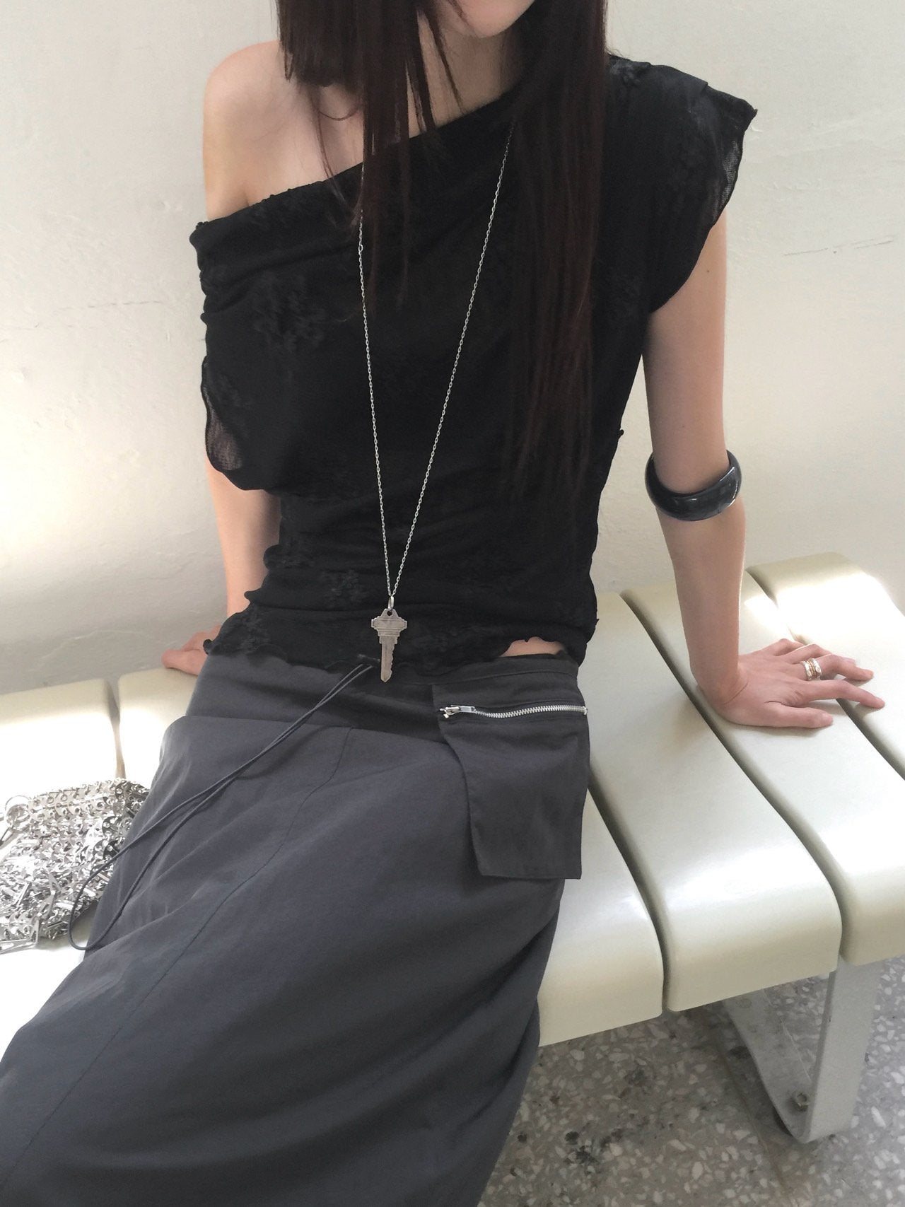 Nweol low rise zip pocket maxi skirt in Black, styled on model front view with beige cardigan