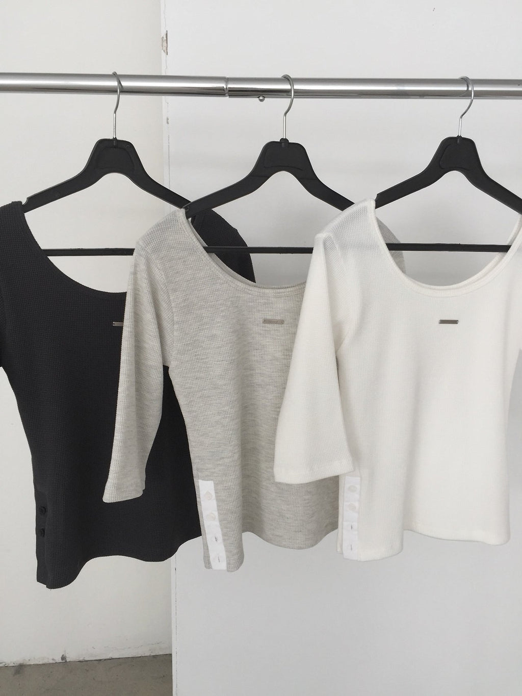 Nweol waffle knit crop top in White Melange, styled on model front view with bag