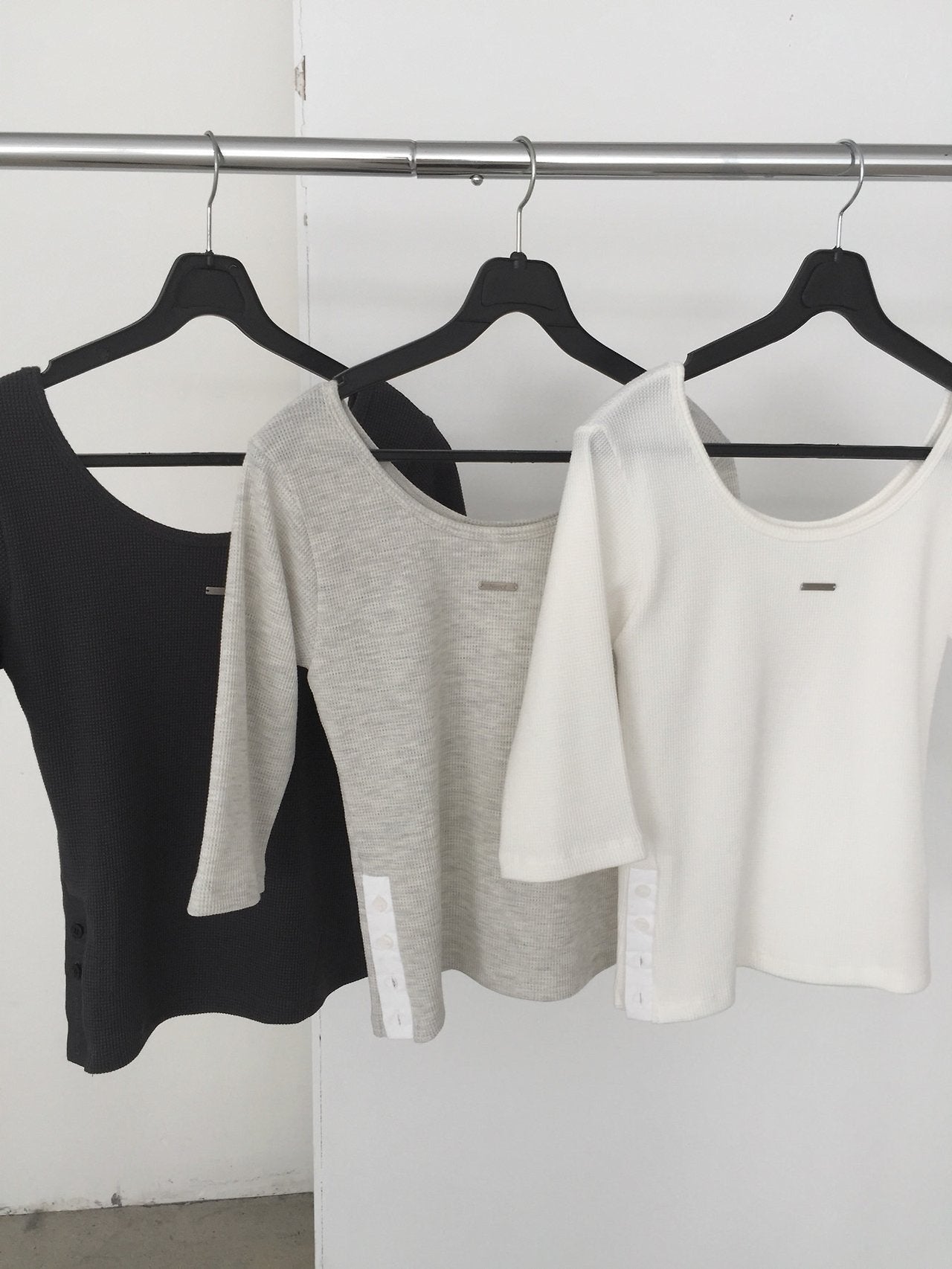 Nweol waffle knit crop top in White Melange, styled on model front view with bag