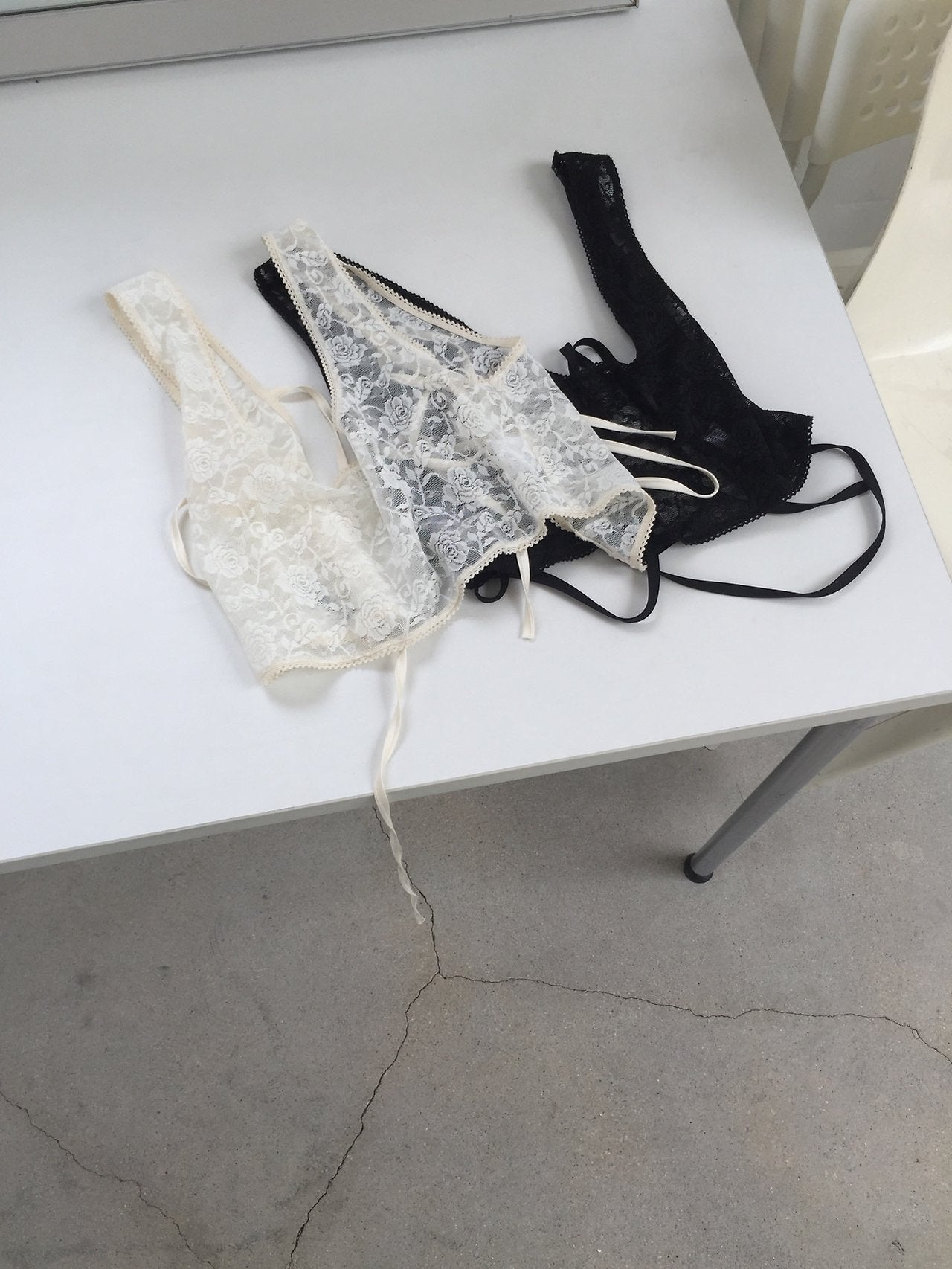 Nweol floral lace sheer bustier in Cream and Black, two colorways product flat lay on white table