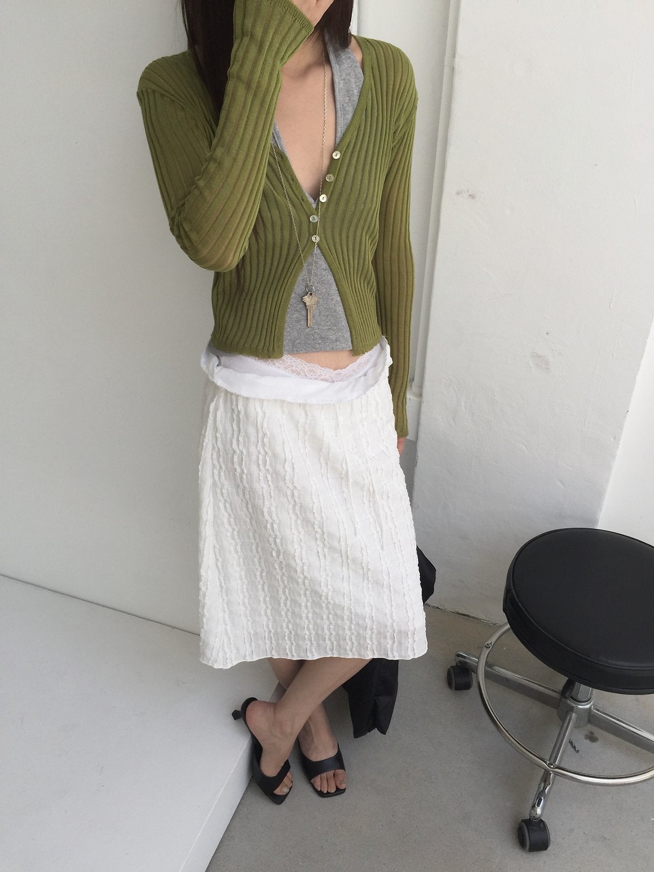 Nweol bubble texture midi skirt in Ivory, styled on model front view walking with black bag and olive cardigan