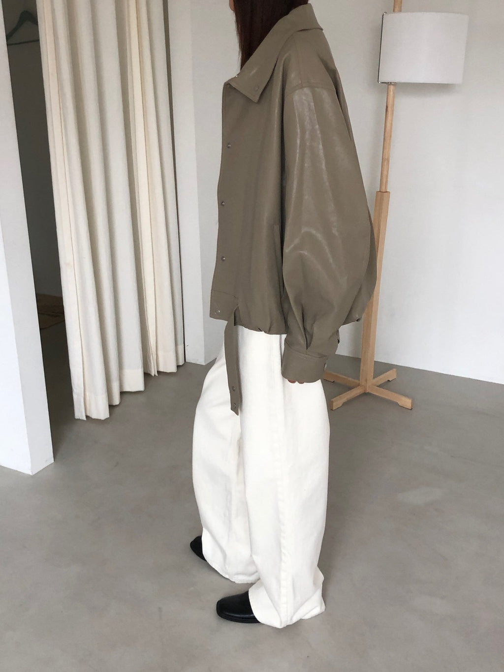 Close-up of beige jacket hem, sleeve and snap cuff