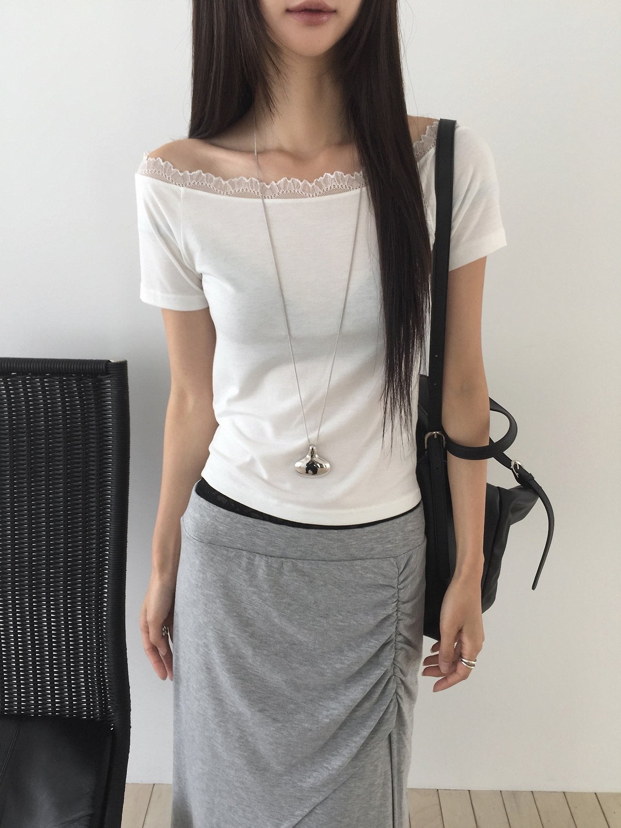 Nweol lace trim off-shoulder top in White, front view seated with necklace