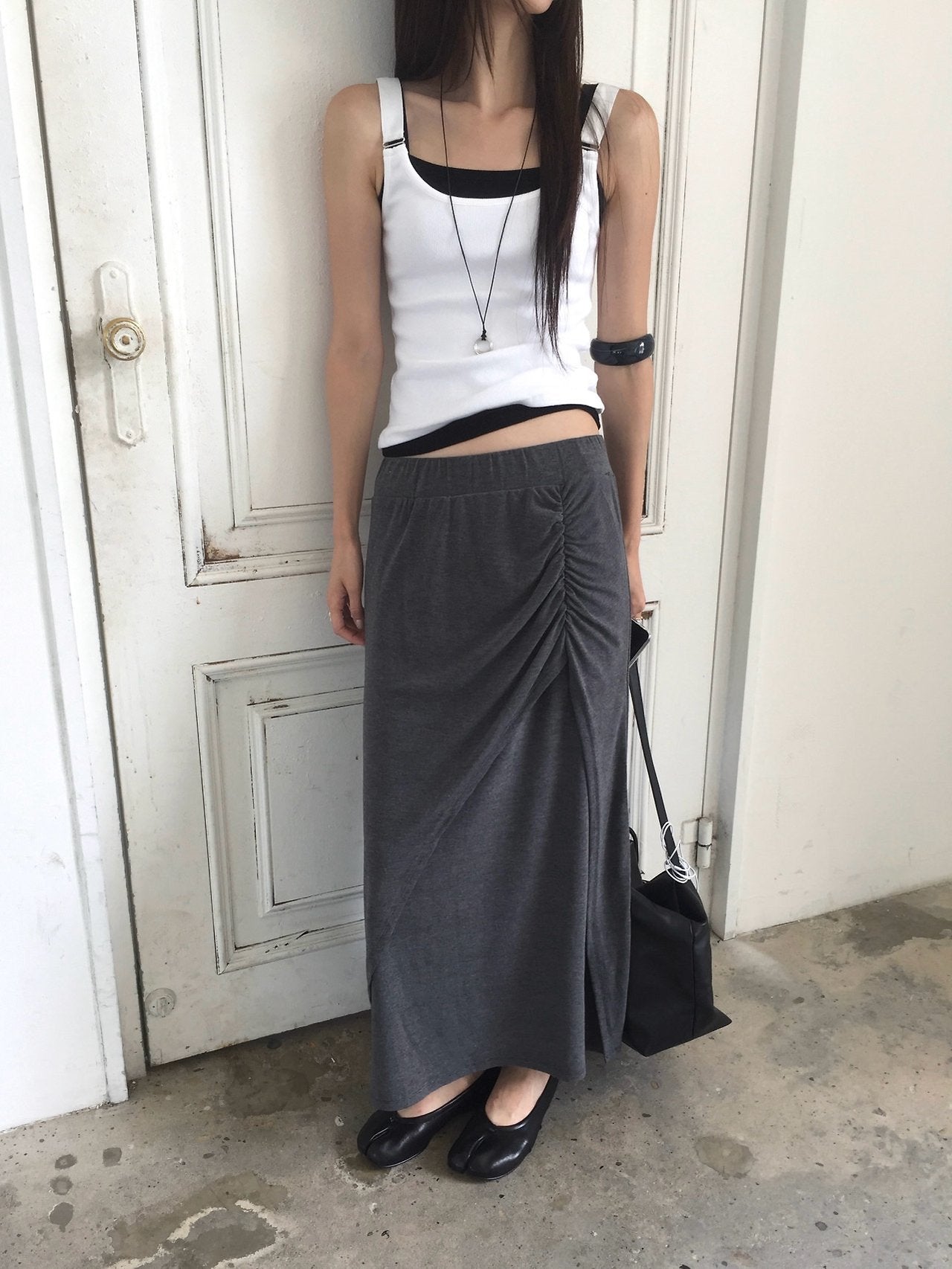 Nweol side ruched maxi skirt in Grey, styled on model front view with white lace trim top and black loafers