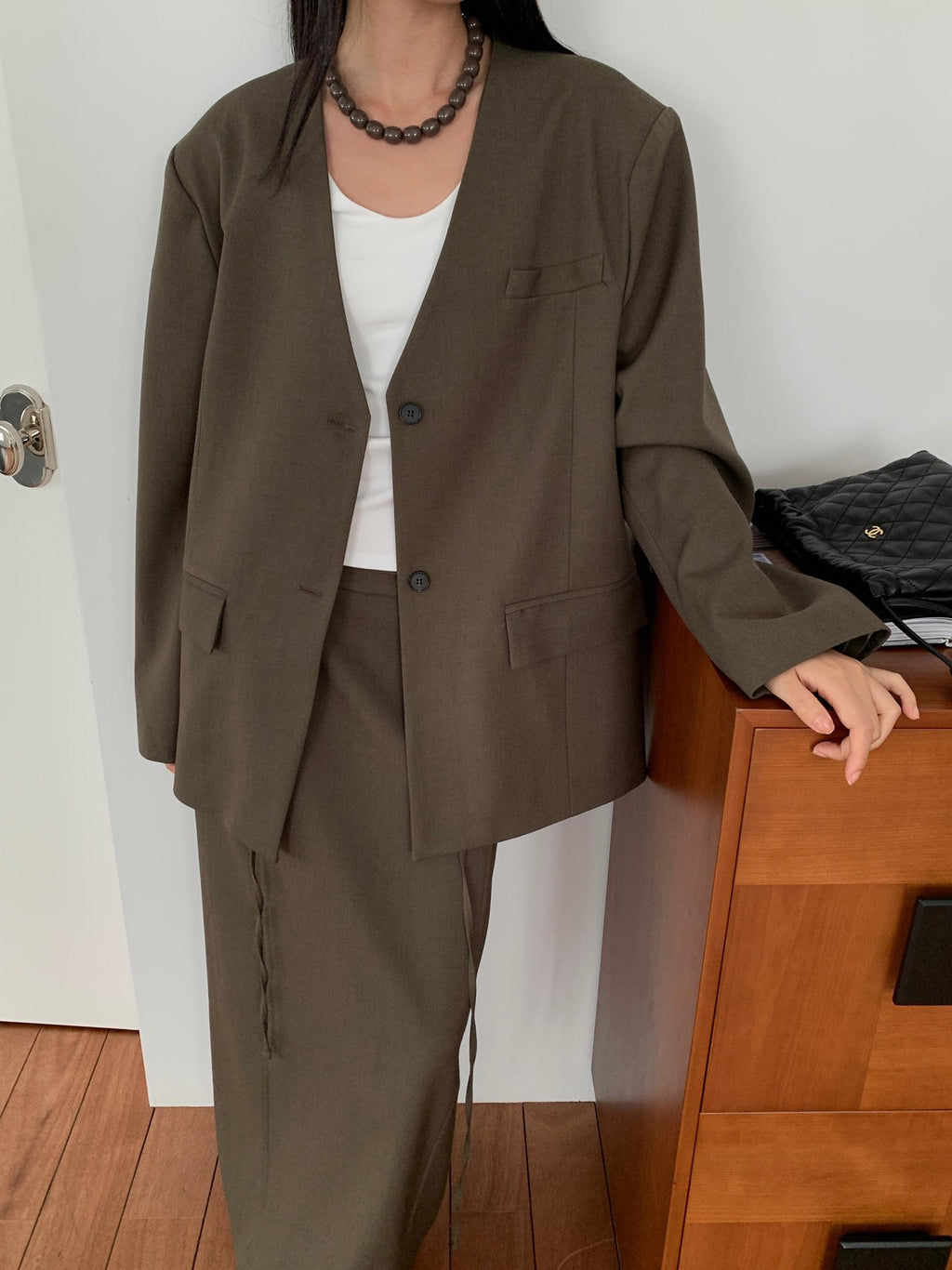 Black collarless jacket front view