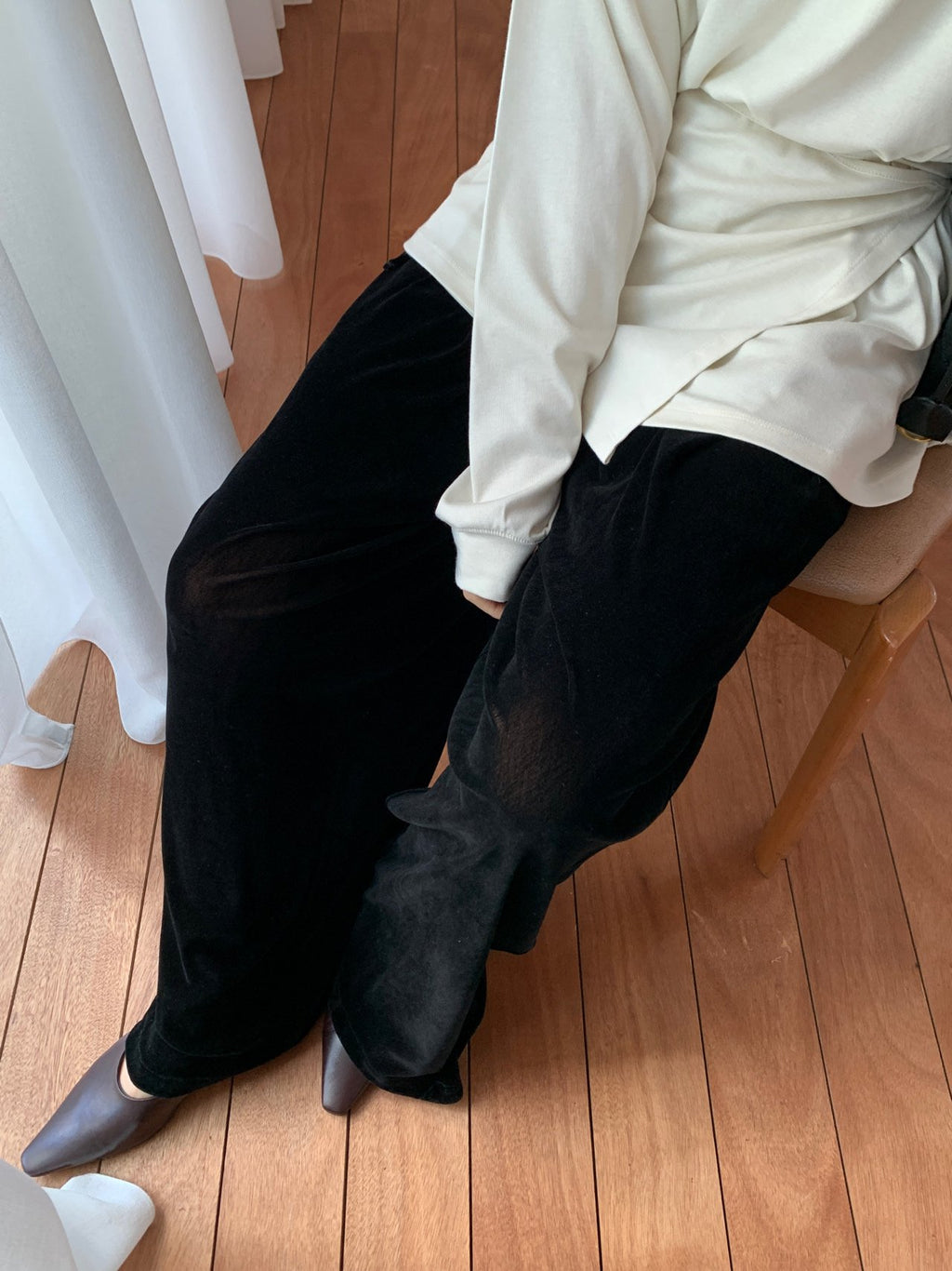 Black velvet wide-leg pants styled with a jacket