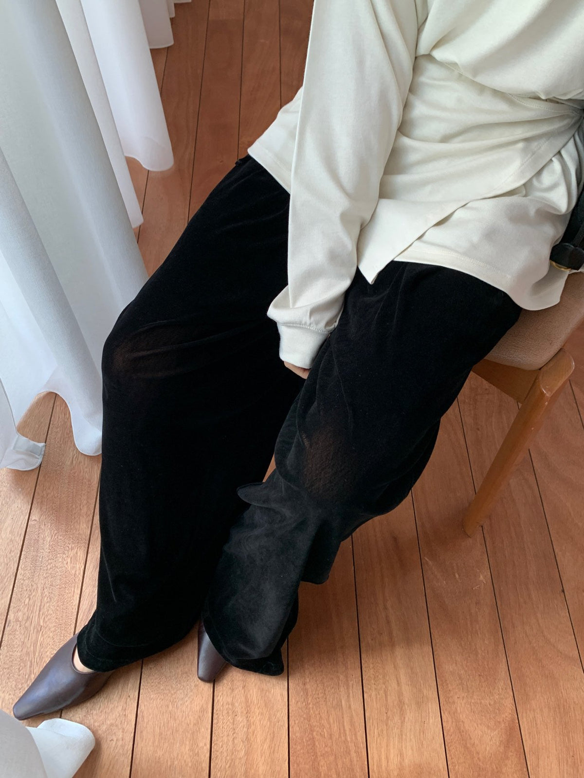Black velvet wide-leg pants styled with a jacket