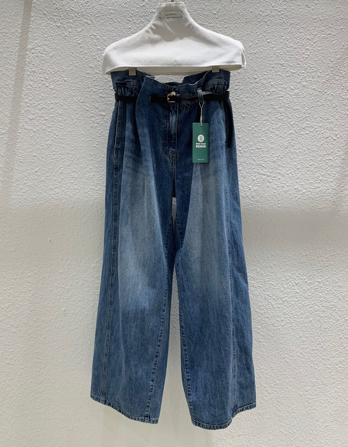 Front view of blue wide-leg jeans with included black belt