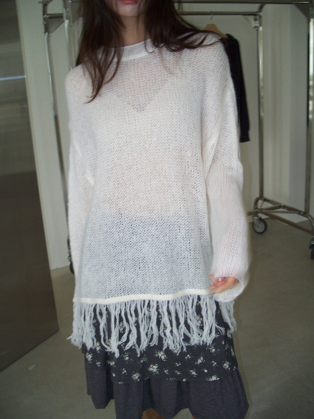 Open-Knit Fringe Sweater Ivory and Charcoal hanging on rack front view