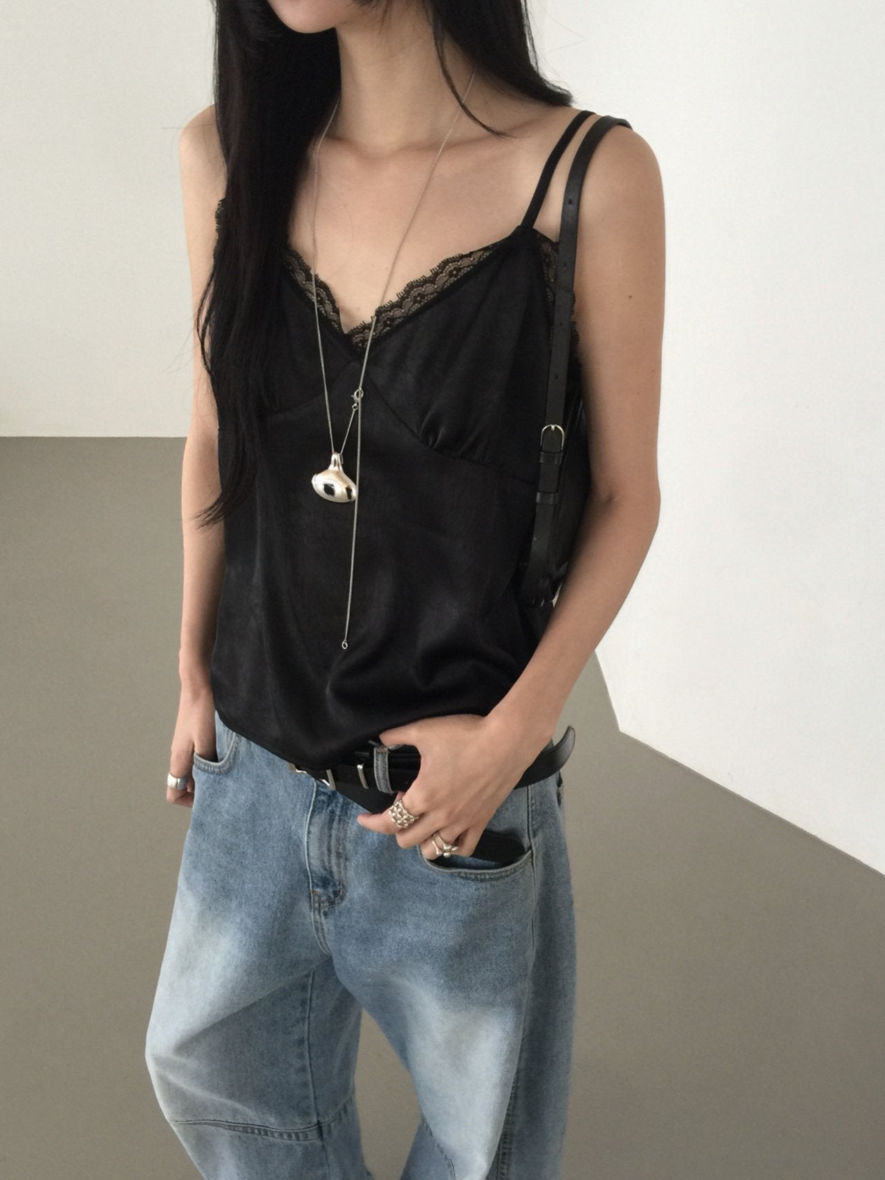 Nweol lace trim satin tank top in Ivory, styled on model mirror selfie front view with light blue wide leg jeans