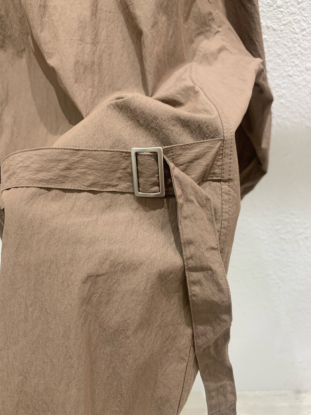 Close-up of Lucysalon belted shirt button cuffs
