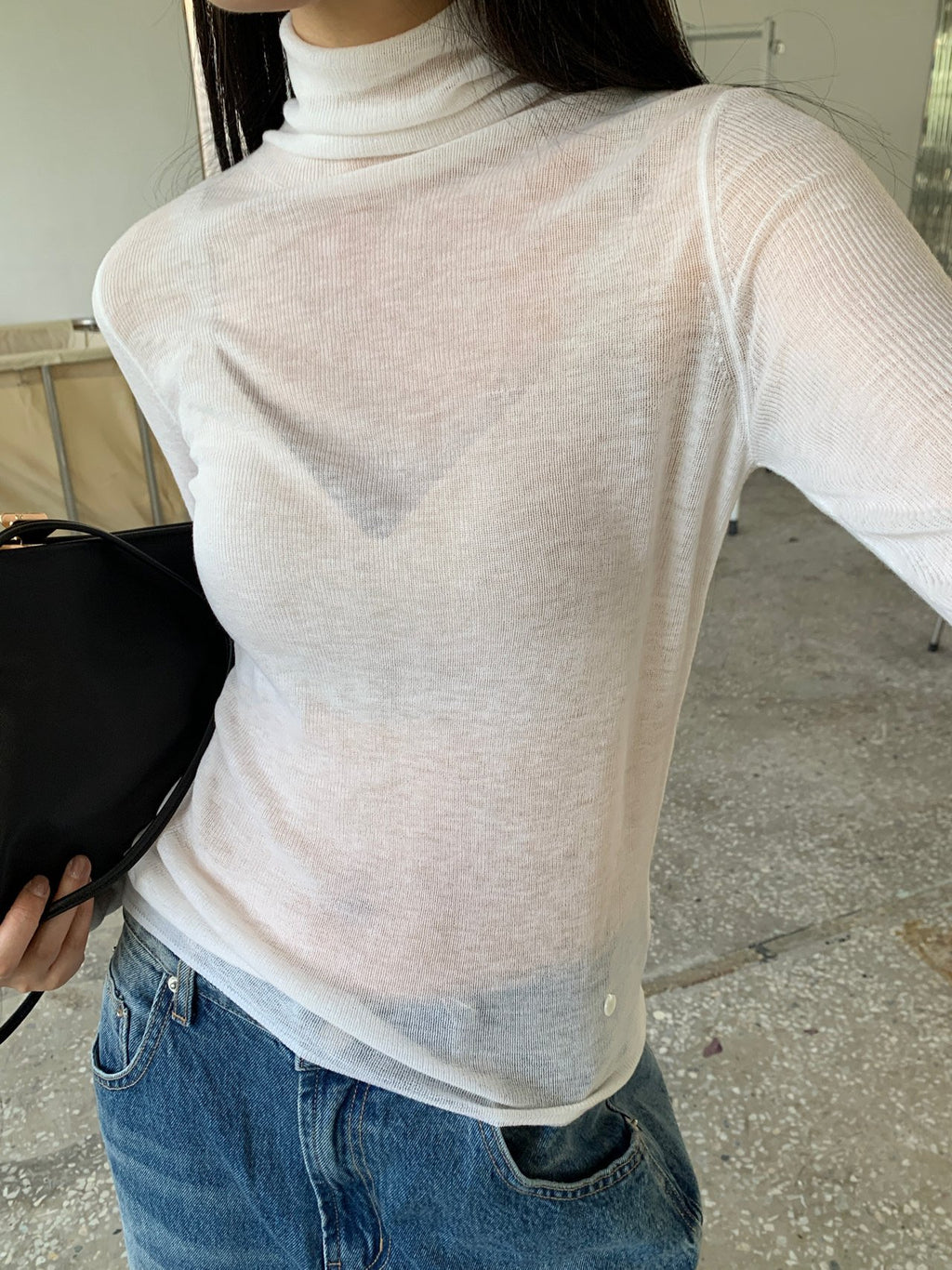 Close-up of grey knit sweater hem and texture