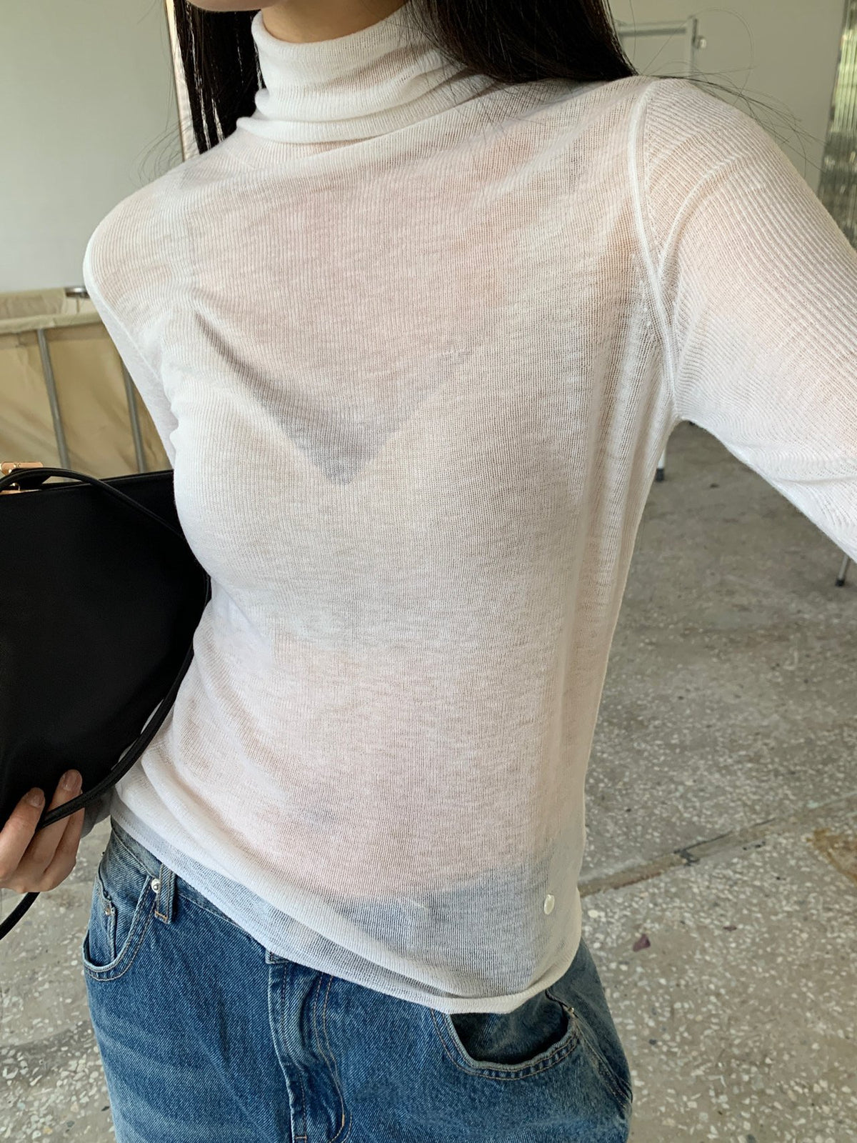 Close-up of grey knit sweater hem and texture