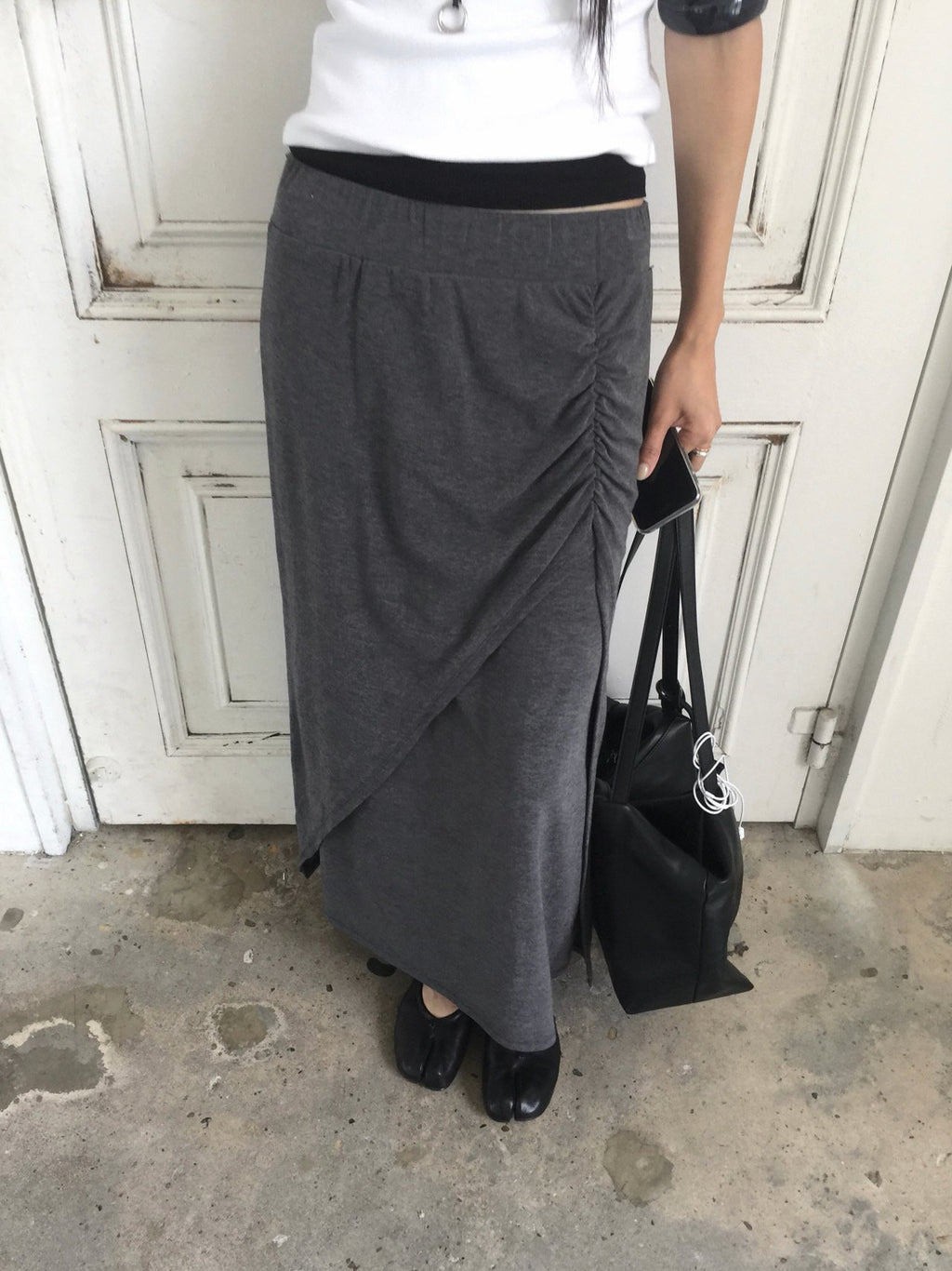 Nweol side ruched maxi skirt in Grey, styled on model front view close-up ruching and slit detail with white lace trim top