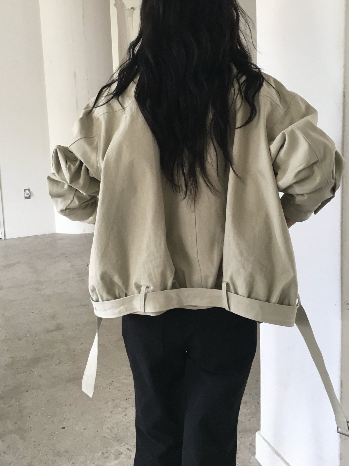 Back view of khaki beige cotton blouson jacket with gathered belted hem