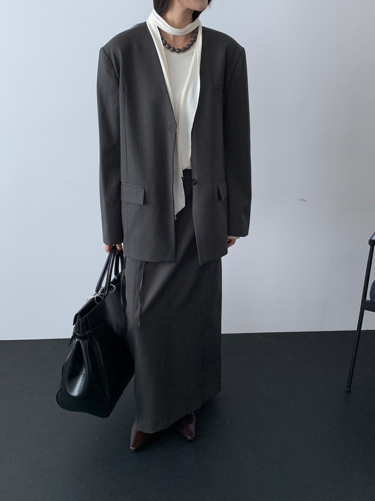 Black collarless jacket close-up