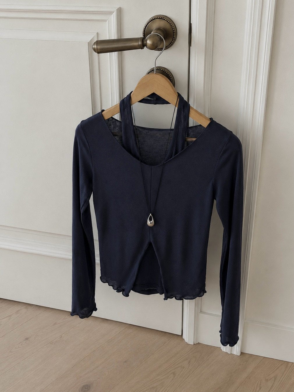 Beige long-sleeve V-neck top layered over a matching halter tank
