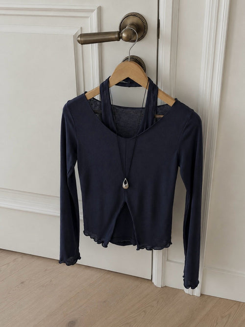 Beige long-sleeve V-neck top layered over a matching halter tank