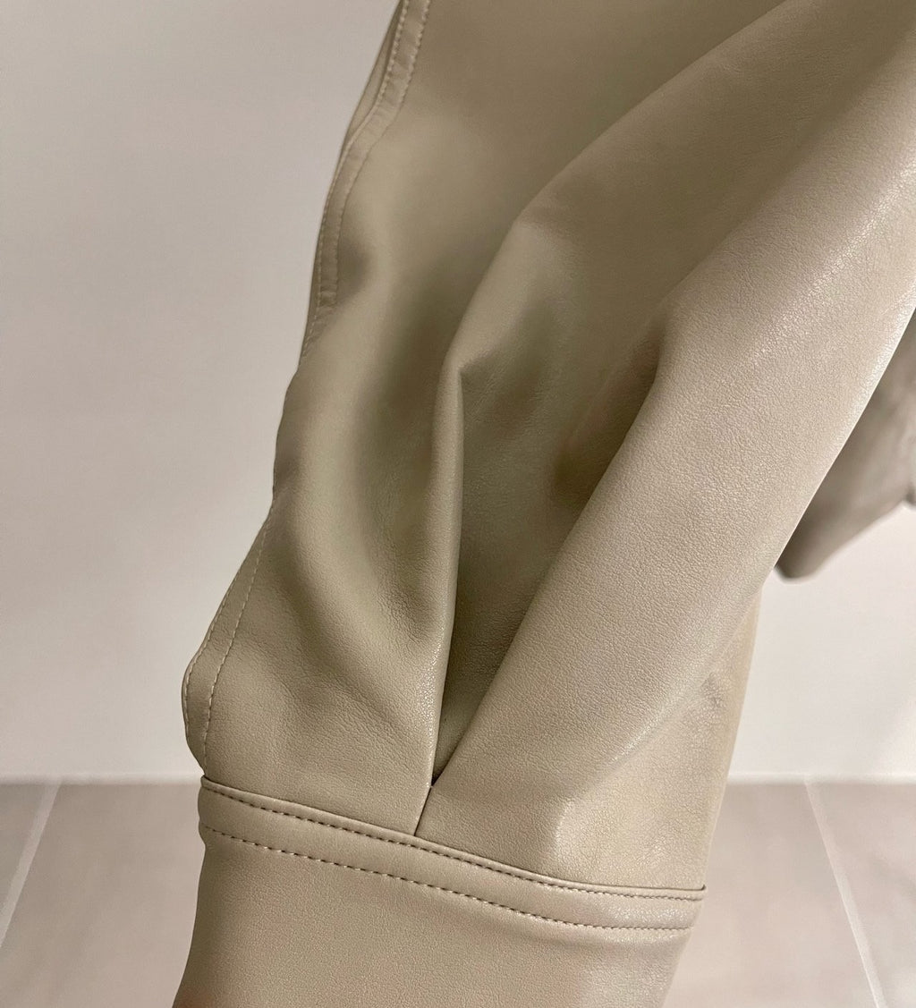 Full beige snap-front jacket displayed on a hanger