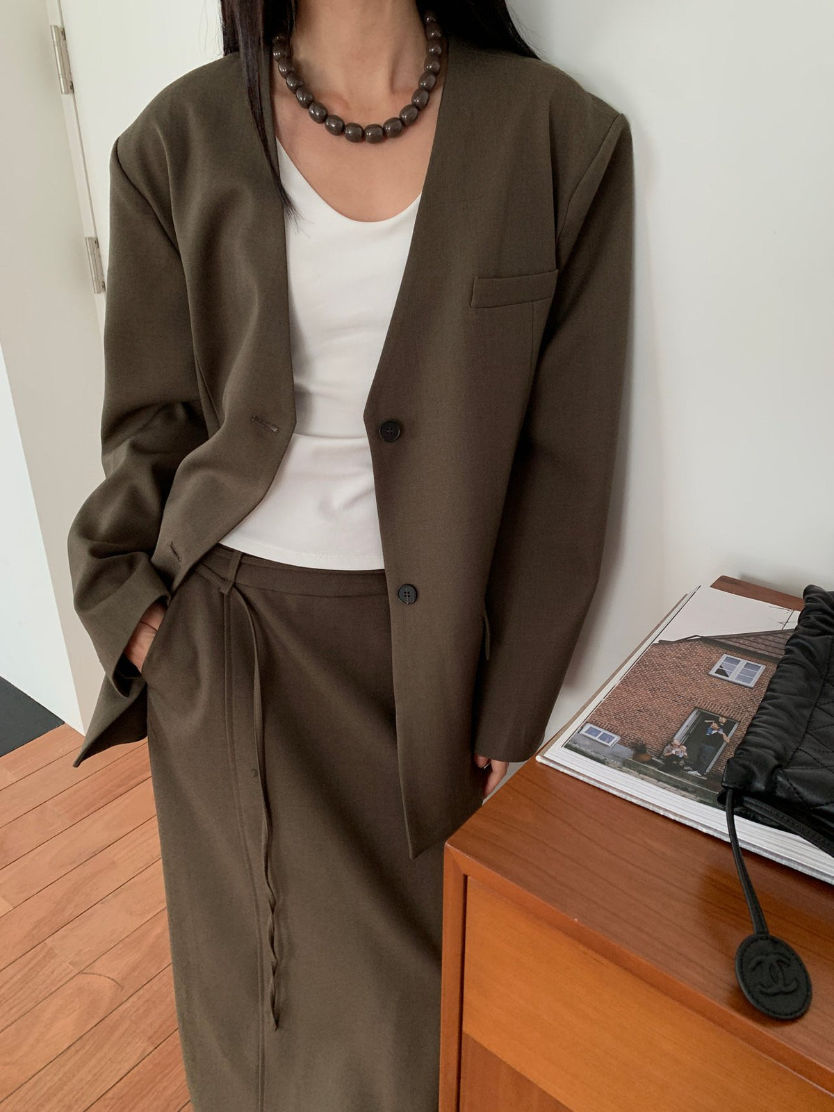 Charcoal collarless jacket side view with skirt