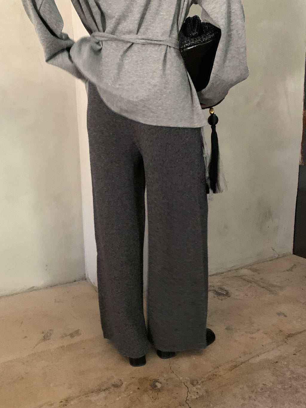 Brown, charcoal and black knit pants displayed together