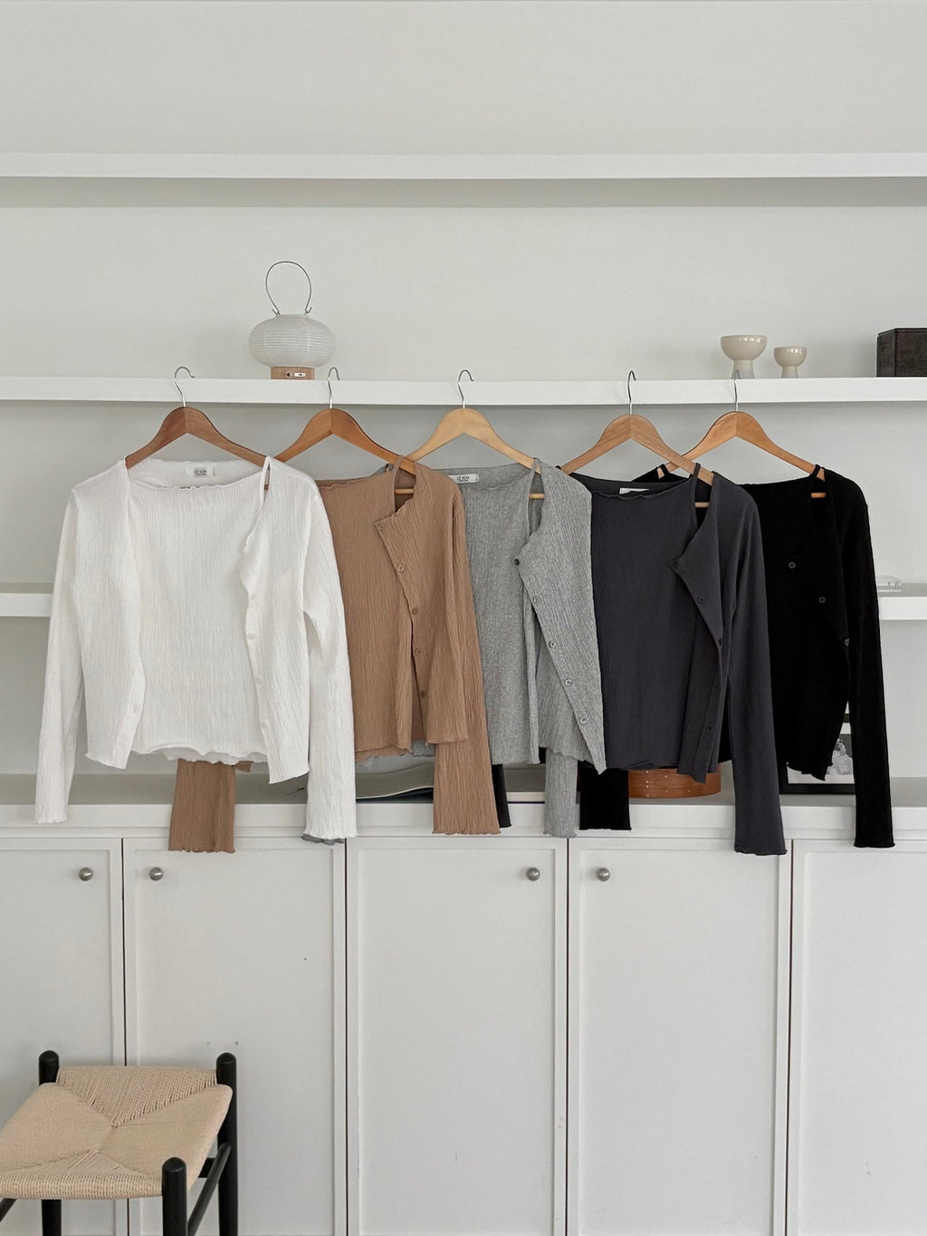 Front view of ivory pleated cardigan over a matching tank top