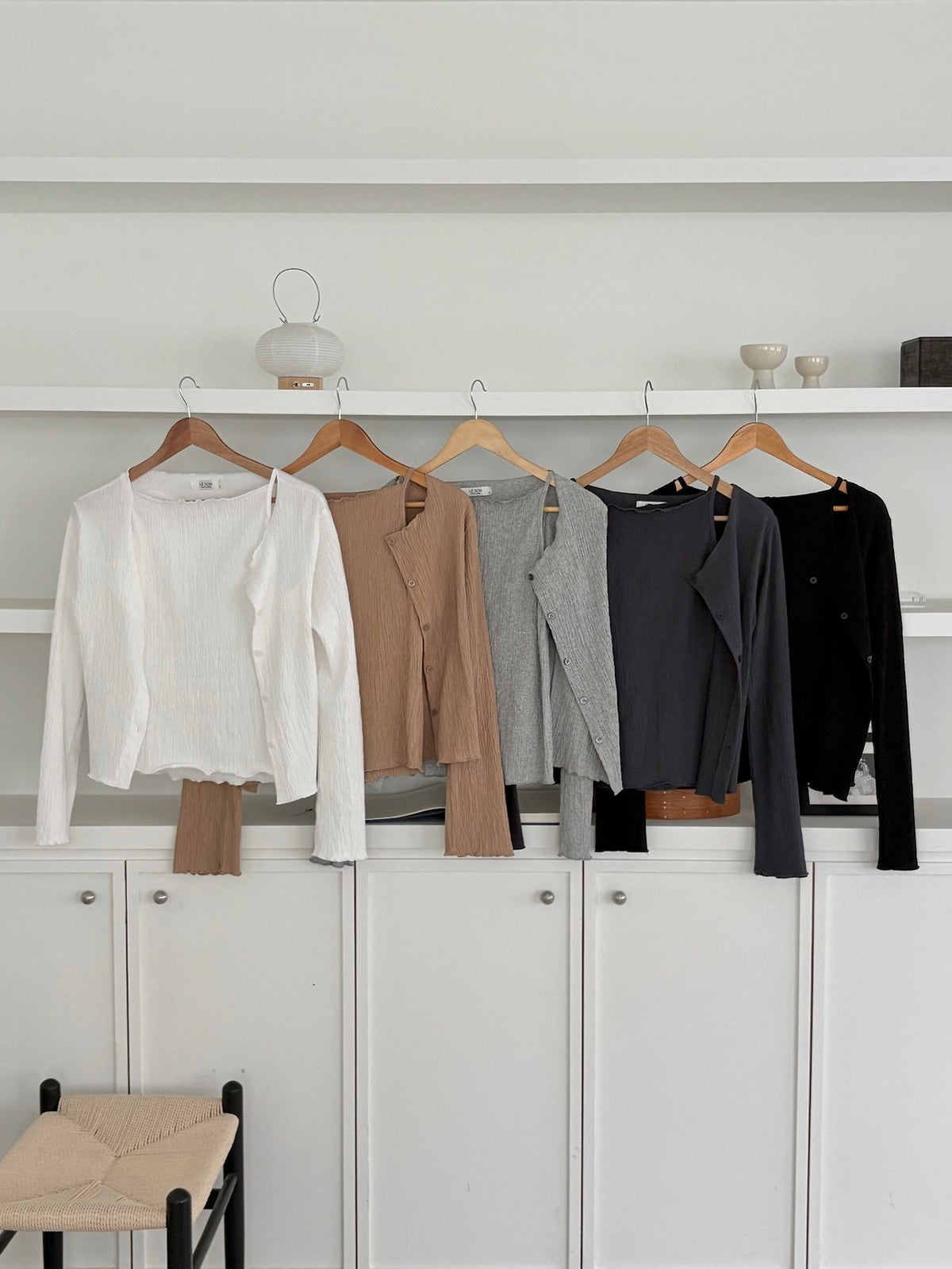 Front view of ivory pleated cardigan over a matching tank top